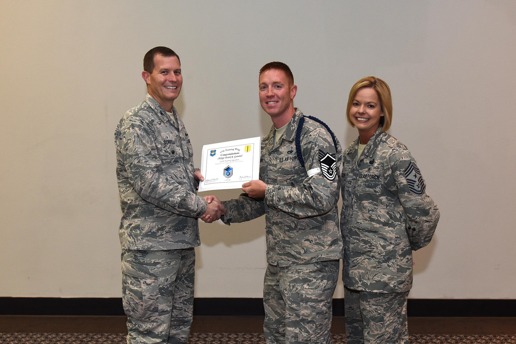 U.S. Air Force Master Sgt. select Derek Gammel, 315th Training Squadron, receives his certificate of selection from Col. Jeffrey Sorrell, 17th Training Wing vice commander, and Chief Master Sergeant Bobbie Riensche, 17th Training Wing command chief, during the Master Sergeant Release Party at the Event Center on Goodfellow Air Force Base, Texas, May 24, 2017.