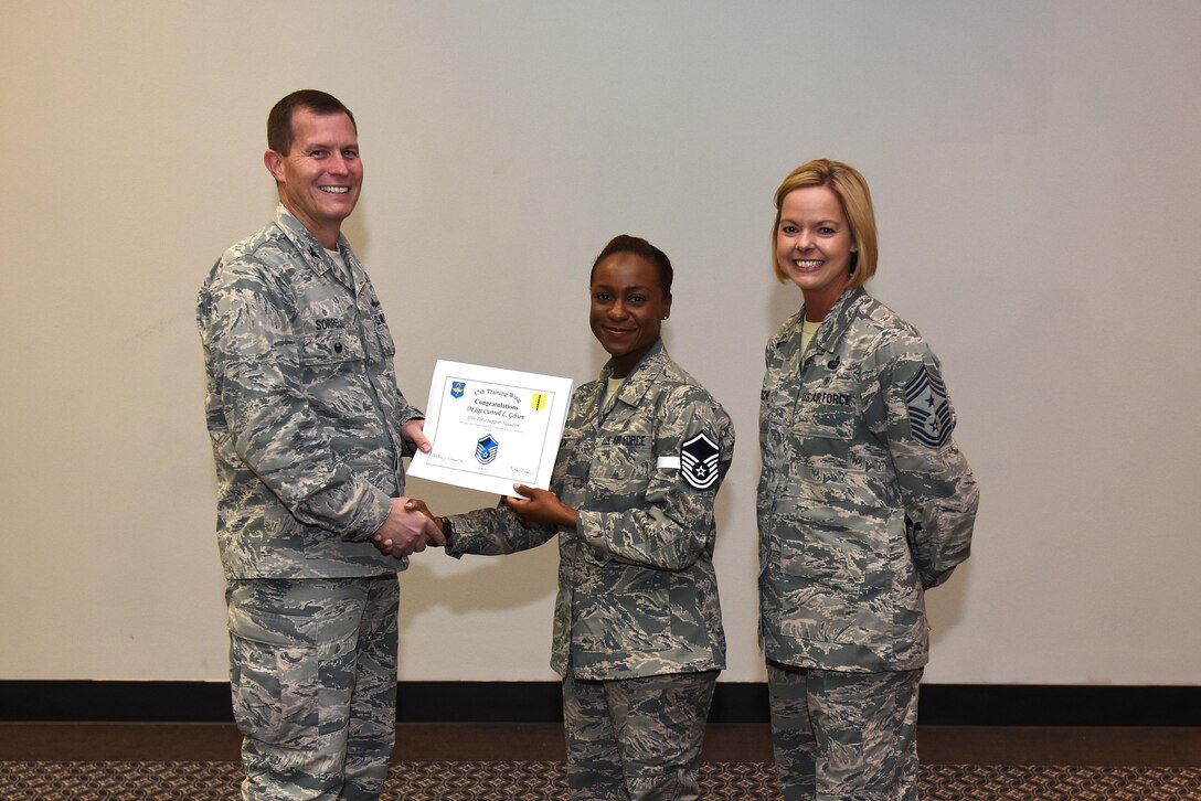 U.S. Air Force Master Sgt. select Curtrell Gibson, 17th Force Support Squadron, receives her certificate of selection from Col. Jeffrey Sorrell, 17th Training Wing vice commander, and Chief Master Sergeant Bobbie Riensche, 17th Training Wing command chief, during the Master Sergeant Release Party at the Event Center on Goodfellow Air Force Base, Texas, May 24, 2017.