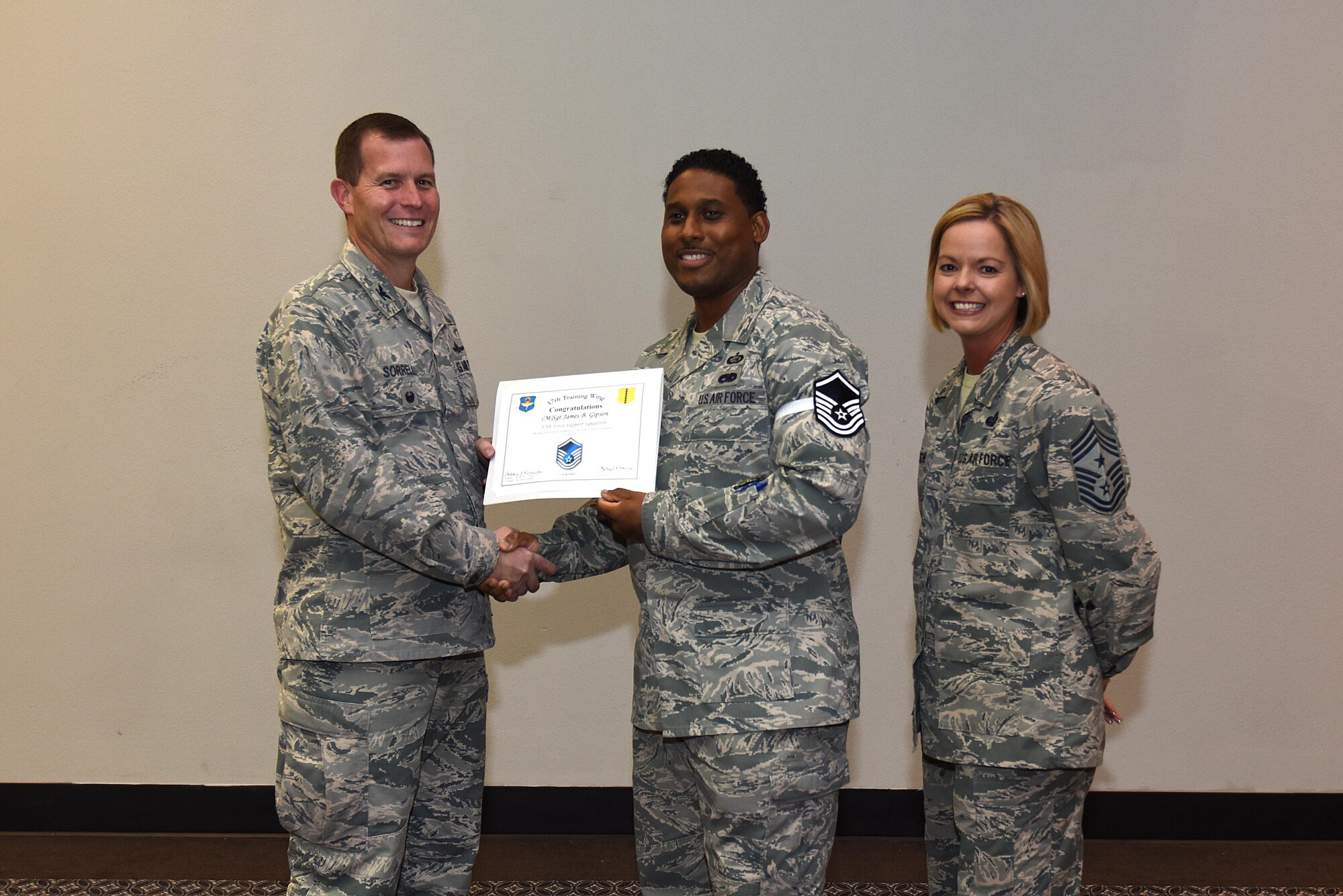 U.S. Air Force Master Sgt. select James Gipson, 17th Force Support Squadron, receives his certificate of selection from Col. Jeffrey Sorrell, 17th Training Wing vice commander, and Chief Master Sergeant Bobbie Riensche, 17th Training Wing command chief, during the Master Sergeant Release Party at the Event Center on Goodfellow Air Force Base, Texas, May 24, 2017.