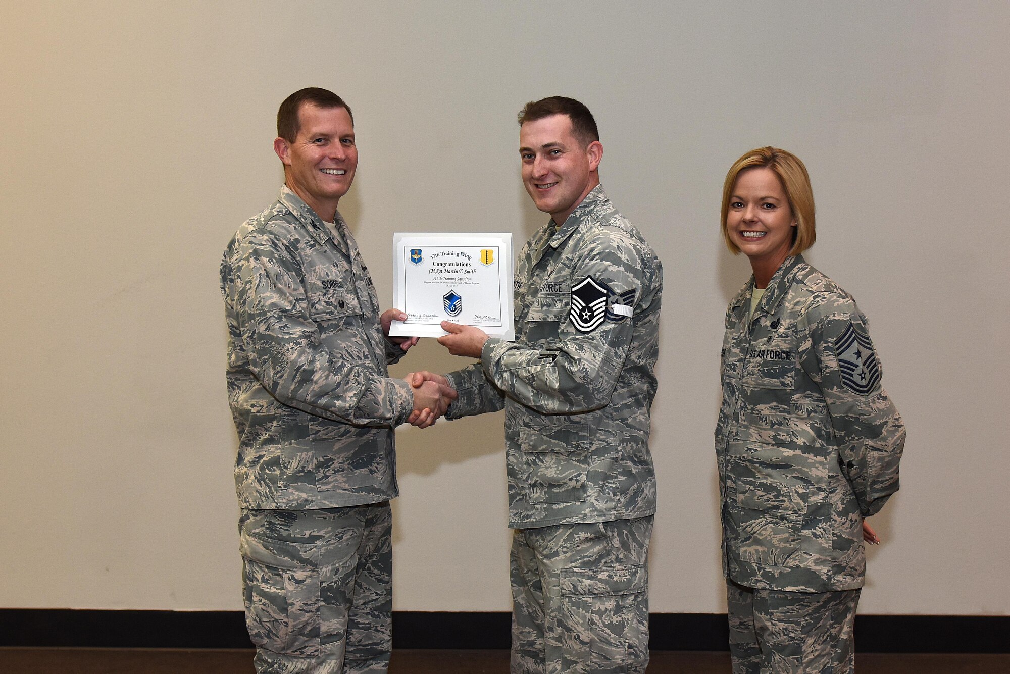 U.S. Air Force Master Sgt. select Martin Smith, 315th Training Squadron, receives his certificate of selection from Col. Jeffrey Sorrell, 17th Training Wing vice commander, and Chief Master Sergeant Bobbie Riensche, 17th Training Wing command chief, during the Master Sergeant Release Party at the Event Center on Goodfellow Air Force Base, Texas, May 24, 2017.