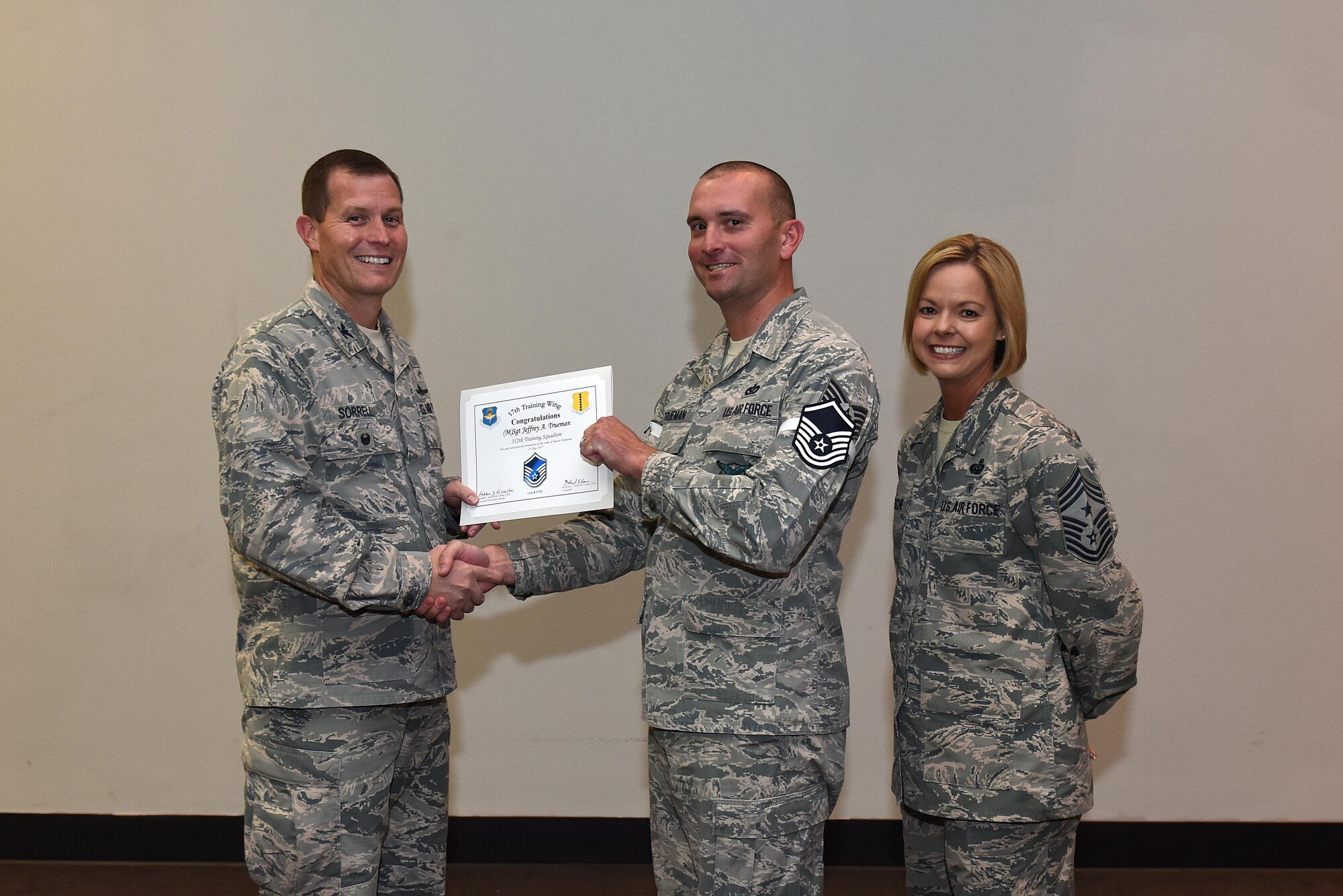 U.S. Air Force Master Sgt. select Jeffrey Trueman, 312th Training Squadron, receives his certificate of selection from Col. Jeffrey Sorrell, 17th Training Wing vice commander, and Chief Master Sergeant Bobbie Riensche, 17th Training Wing command chief, during the Master Sergeant Release Party at the Event Center on Goodfellow Air Force Base, Texas, May 24, 2017.eceives his certificate of selection from Lt. Col. Jeffrey Sorrell, 17th Training Wing Vice Commander, and Chief Master Sergeant Bobbie Riensche, 17th Training Wing Command Chief, during the Master Sergeant Release Party at the Event Center on Goodfellow Air Force Base, Texas, May 24, 2017. (U.S. Air Force photo by Airman 1st Class Caelynn Ferguson/ Released)
