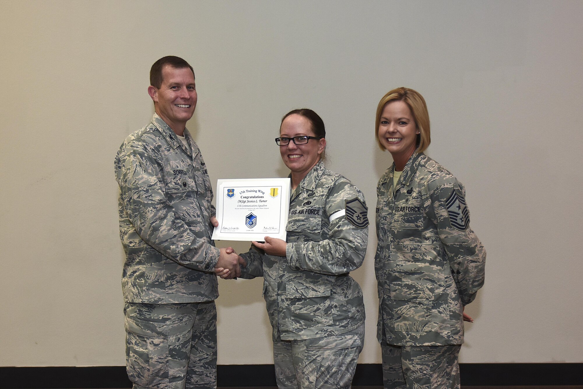 U.S. Air Force Master Sgt. select Jessica Turner, 17th Communications Squadron, receives her certificate of selection from Col. Jeffrey Sorrell, 17th Training Wing vice commander, and Chief Master Sergeant Bobbie Riensche, 17th Training Wing command chief, during the Master Sergeant Release Party at the Event Center on Goodfellow Air Force Base, Texas, May 24, 2017.