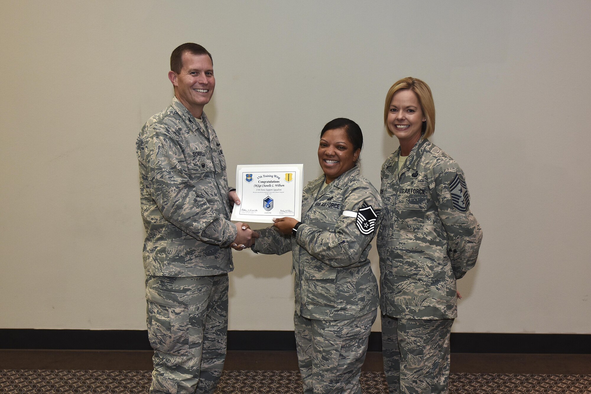 U.S. Air Force Master Sgt. select Chanelle Wilburn, 17th Force Support Squadron, receives her certificate of selection from Col. Jeffrey Sorrell, 17th Training Wing vice commander, and Chief Master Sergeant Bobbie Riensche, 17th Training Wing command chief, during the Master Sergeant Release Party at the Event Center on Goodfellow Air Force Base, Texas, May 24, 2017.