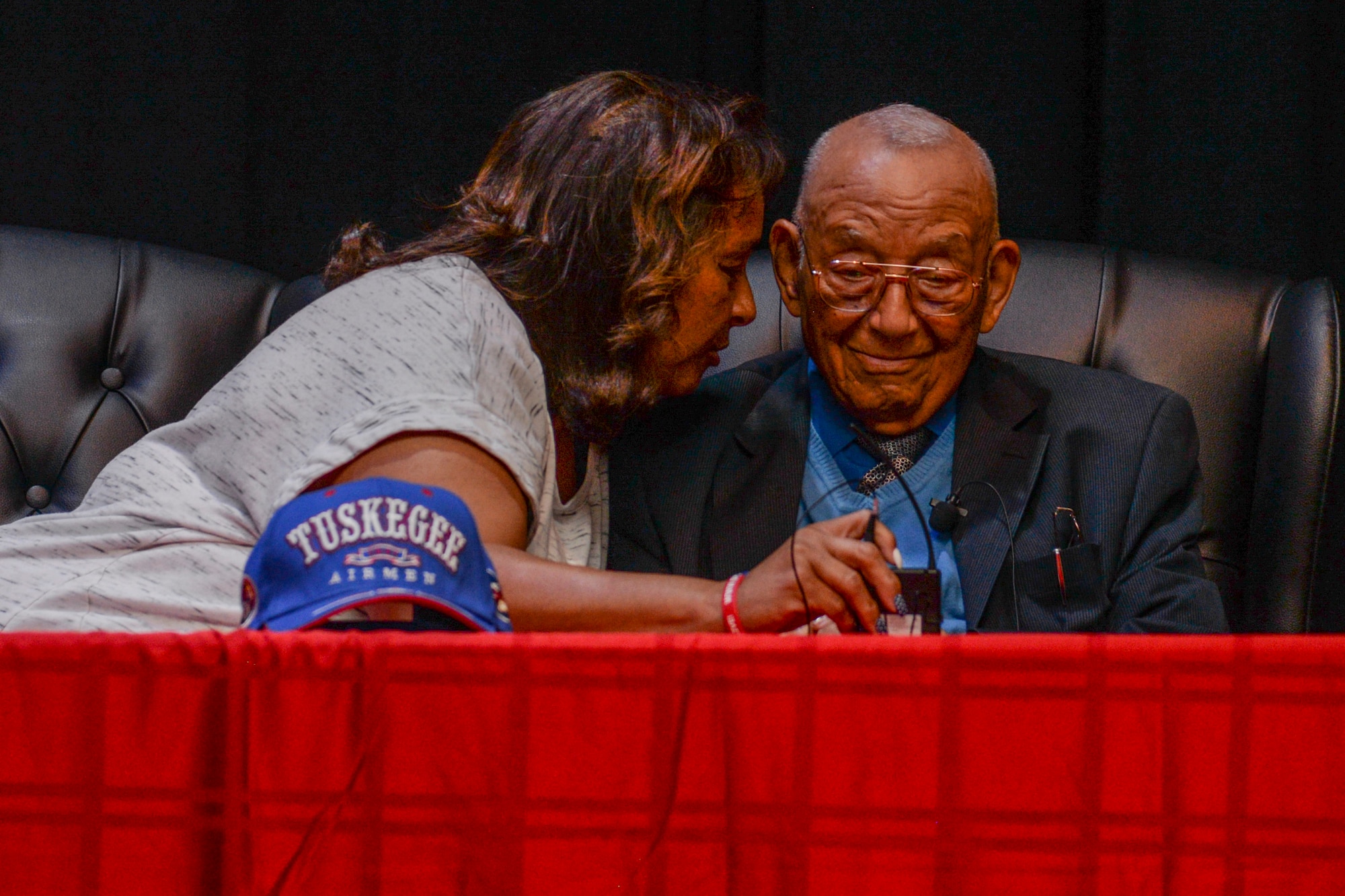 Karen Friend repeats a question to retired Lt. Col. Robert Friend during a presentation May 8, 2017 at the at the Scott Library Auditorium, Scott Air Force Base, Illinois. Friend is one of 16 livingTuskegee Airman and answered questions from crowd members about his time serving.(U.S. Air Force photos by Airman Chad Gorecki)