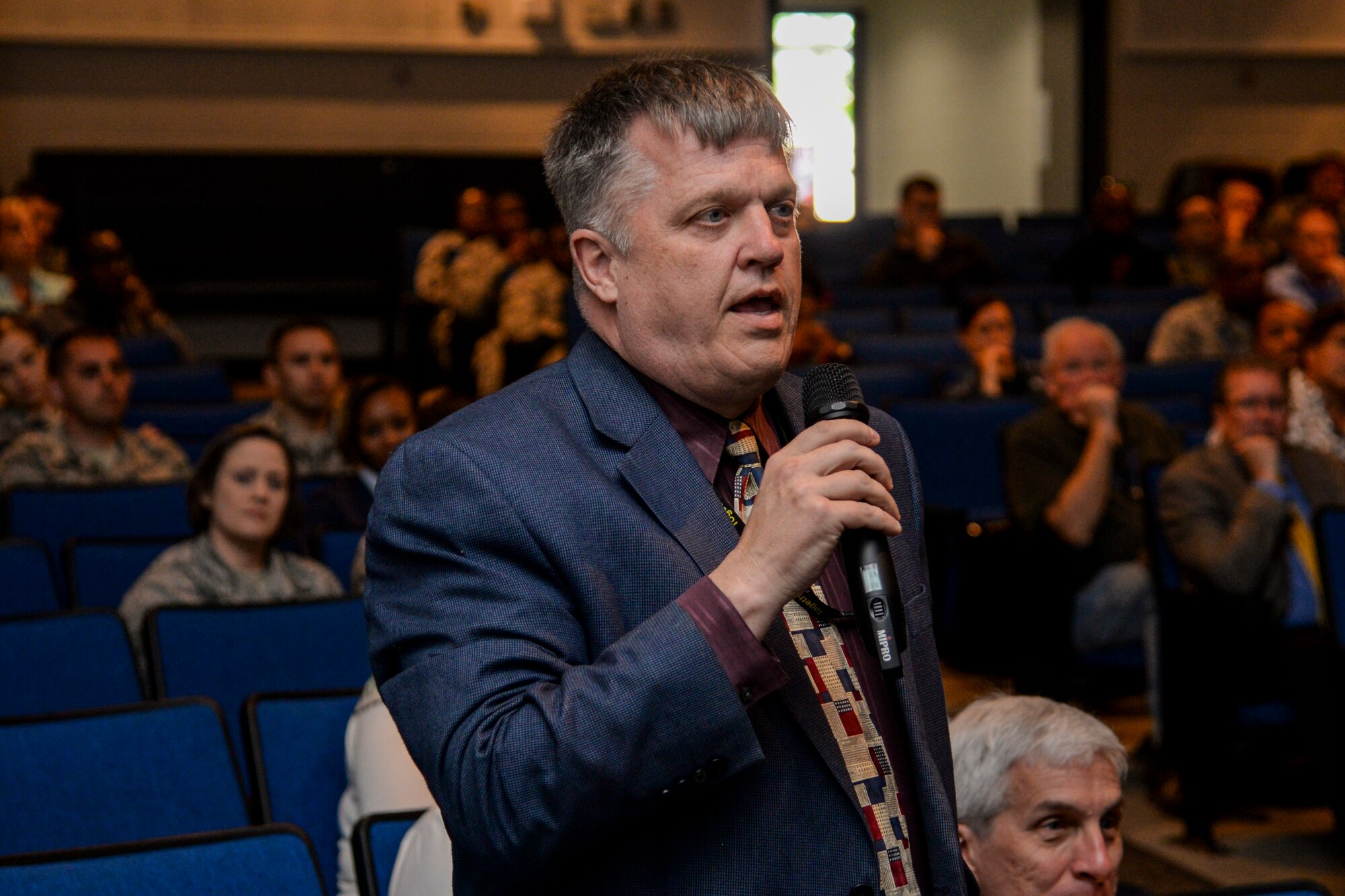 A crowd member asks retired Lt. Col. Robert Friend a question during a presentation May 8, 2017 at the Scott Library Auditorium, Scott Air Force Base, Illinois. Friend answered questions from Team Scott members regarding his time serving as a Tuskegee Airman.(U,S. Air Force photo by Airman Chad Gorecki)