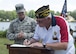 Ed Moczulski, Veterans of Foreign Wars Post 6483 commander, signs an agreement that formally adopts the 436th Logistics Readiness Squadron under the VFW’s Adopt a Unit Program May 19, 2017, in Milford, Del. This adoption was organized by Tech. Sgt. Steven Hall, 436th LRS vehicle management, who is a member of both the LRS and VFW Post 6483. (U.S. Air Force photo by Senior Airman Zachary Cacicia)