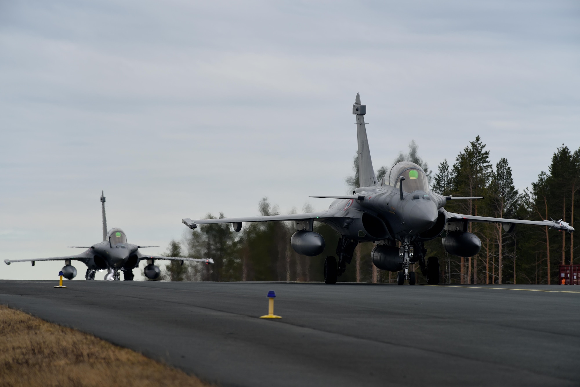 Two French Rafale aircraft taxi to a runway at Rovaniemi Air Base, Finland, May 22, in support of Arctic Challenge 2017. The French are training alongside the U.S. and other allies and partners in Europe, in an effort to maintain the relationships and trust that are essential for ensuring regional security. (U.S. Air Force photo/Airman 1st Class Abby L. Finkel)