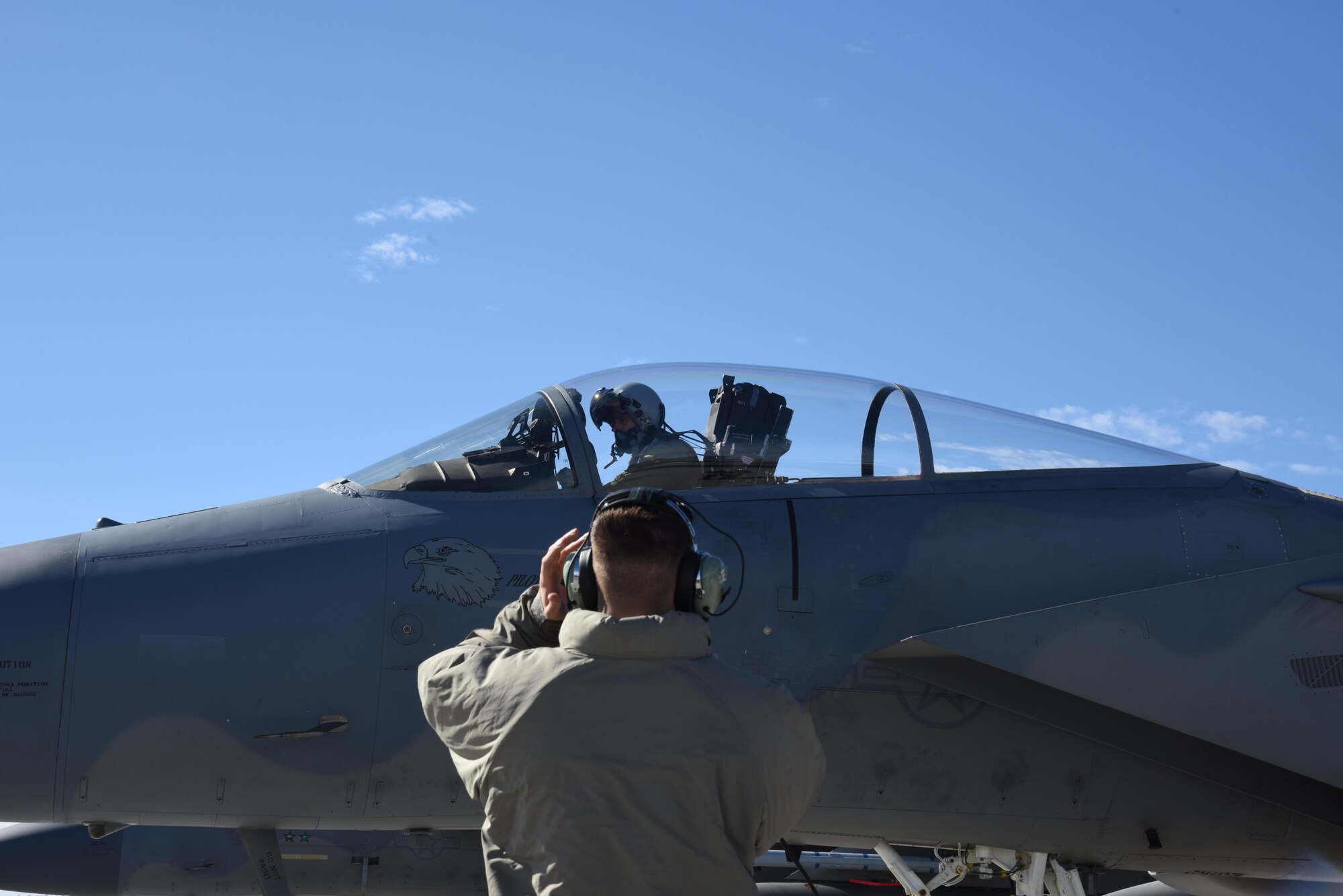 A 493rd Fighter Squadron pilot from the 48th Fighter Wing, Royal Air Force Lakenheath, England, communicates with a maintenance Airman at Rovaniemi Air Base, Finland, May 25, before taking off in support of Arctic Challenge 2017. The U.S. participants in ACE 17 represent America's forward presence, postured alongside our proven, essential NATO allies and partners. U.S. Air Force photo/Airman 1st Class Abby L. Finkel)