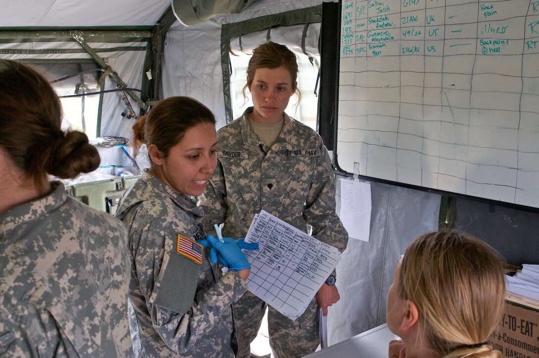 Spc. Tessa Snyder, daytime non-commissioned officer in charge of the 491st Medical Support Group clinic receives situation report from her team about the  simulated casualties as part of Maple Resolve 17, the Canadian Army’s premiere brigade-level validation exercise running May 14-29 at Camp Wainwright, Alberta, Canada. 

More than 650 U.S. Army Soldiers are providing a wide array of combat and support elements. These include sustainment, psychological operations, public affairs, aviation and medical units. Reserve units participating in Maple Resolve 17 will sharpen individual skill sets while enhancing overall unit readiness.