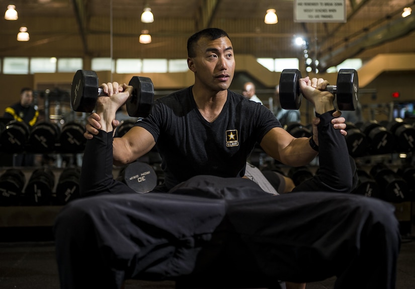 Sgt. 1st Class Jason Lee, a U.S. Army Reserve Soldier from the 200th Military Police Command and a certified Master Fitness Trainer, shows proper form in weight lifting to a group of Soldiers participating in a Performance Triad program organized by him, hosted on Fort Meade, Maryland, May 12, 2017. The three-week fitness program took place from May 5-25 to help Soldiers who had either failed the Army Physical Fitness Test or had been on the Army Body Fat Composition program. The camp focused on the triad of overall health: physical fitness, nutrition and sleep, by providing education and personalized coaching to Soldiers in all three of those phases of life and more. (U.S. Army Reserve photo by Master Sgt. Michel Sauret)