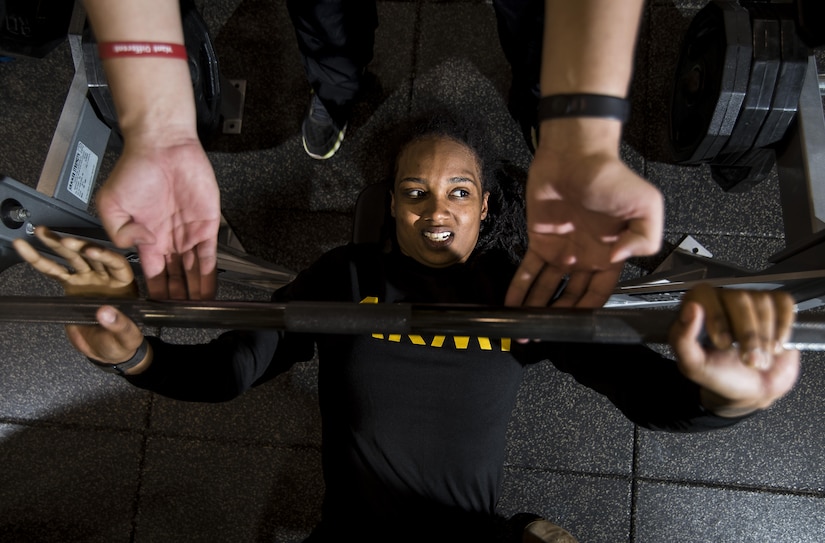 Spc. Jasmine Kearse, a U.S. Army Reserve Soldier from the 200th Military Police Command, bench-presses with the help of a spotter during a Performance Triad program organized by the command and hosted on Fort Meade, Maryland, May 9, 2017. The three-week fitness program took place from May 5-25 to help Soldiers who had either failed the Army Physical Fitness Test or had been on the Army Body Fat Composition program. The camp focused on the triad of overall health: physical fitness, nutrition and sleep, by providing education and personalized coaching to Soldiers in all three of those phases of life and more. (U.S. Army Reserve photo by Master Sgt. Michel Sauret)