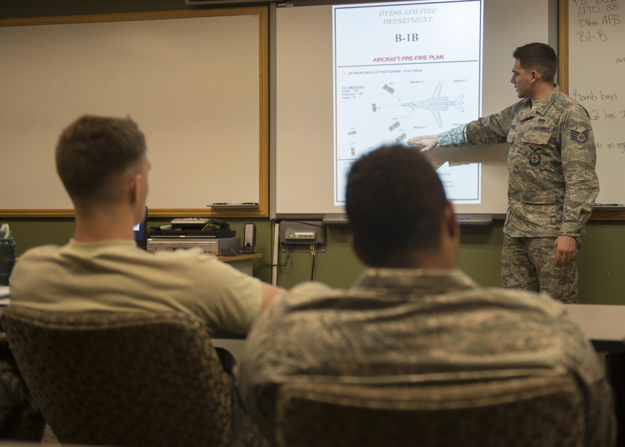 U.S Air Force Staff Sgt. Kevin Wiltrout, 7th Civil Engineer Squadron Fire Prevention craftsman, gives a briefing prior to a group-training exercise at Dyess Air Force Base, Texas, May 22, 2017. The briefing explained possible scenarios and hazards the firefighters may encounter if an aircraft catches fire, and how to extinguish it safely. (U.S. Air Force photo by Airman 1st Class Katherine Miller)