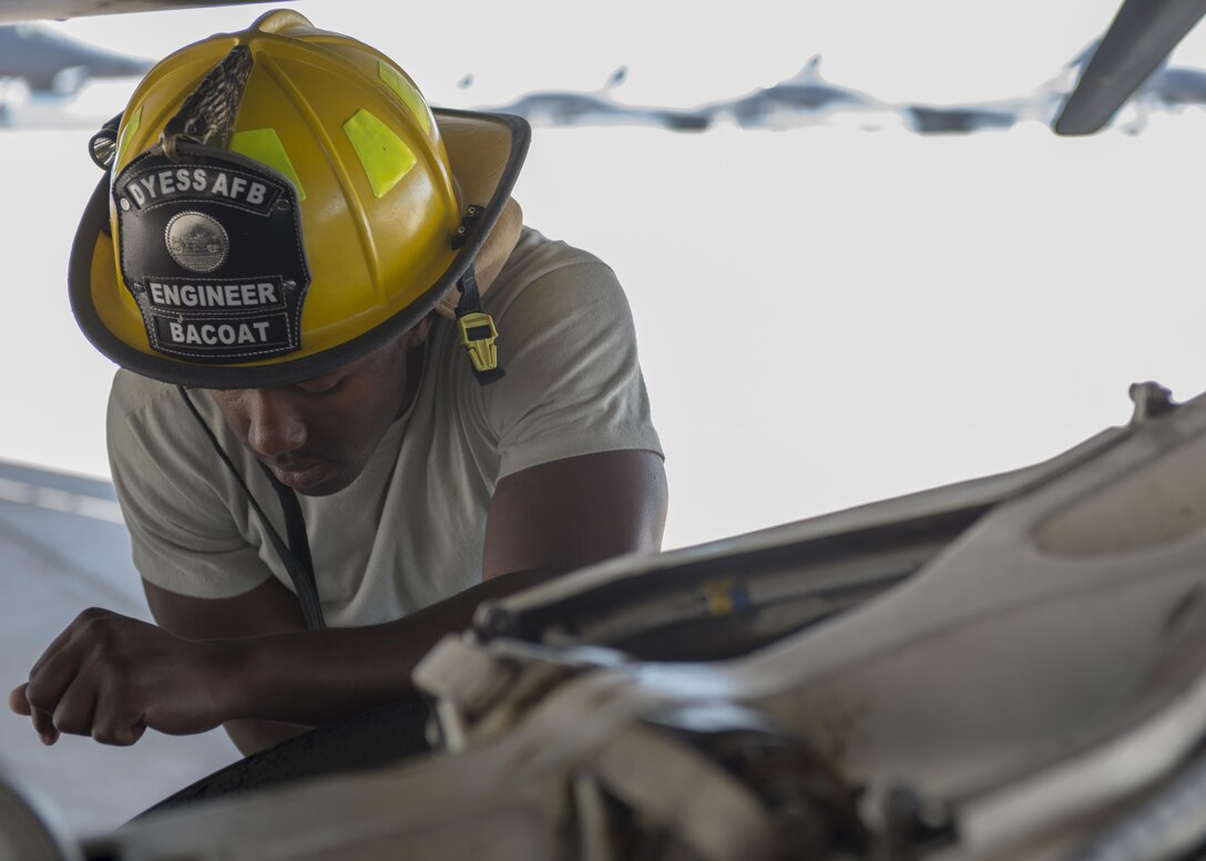 U.S. Air Force Senior Airman Anthony Bacoat, 7th Civil Engineer Squadron Fire Prevention journeyman, assists in a training scenario on a B-1B Lancer at Dyess Air Force Base, Texas, May 22, 2017. Fire Prevention Airmen spend an average of six hours per shift accomplishing training. In addition to training given by leadership for Airmen in upgrade training, the Air Force passes down mandatory monthly training which must be accomplished by every Airman. (U.S. Air Force photo by Airman 1st Class Katherine Miller)