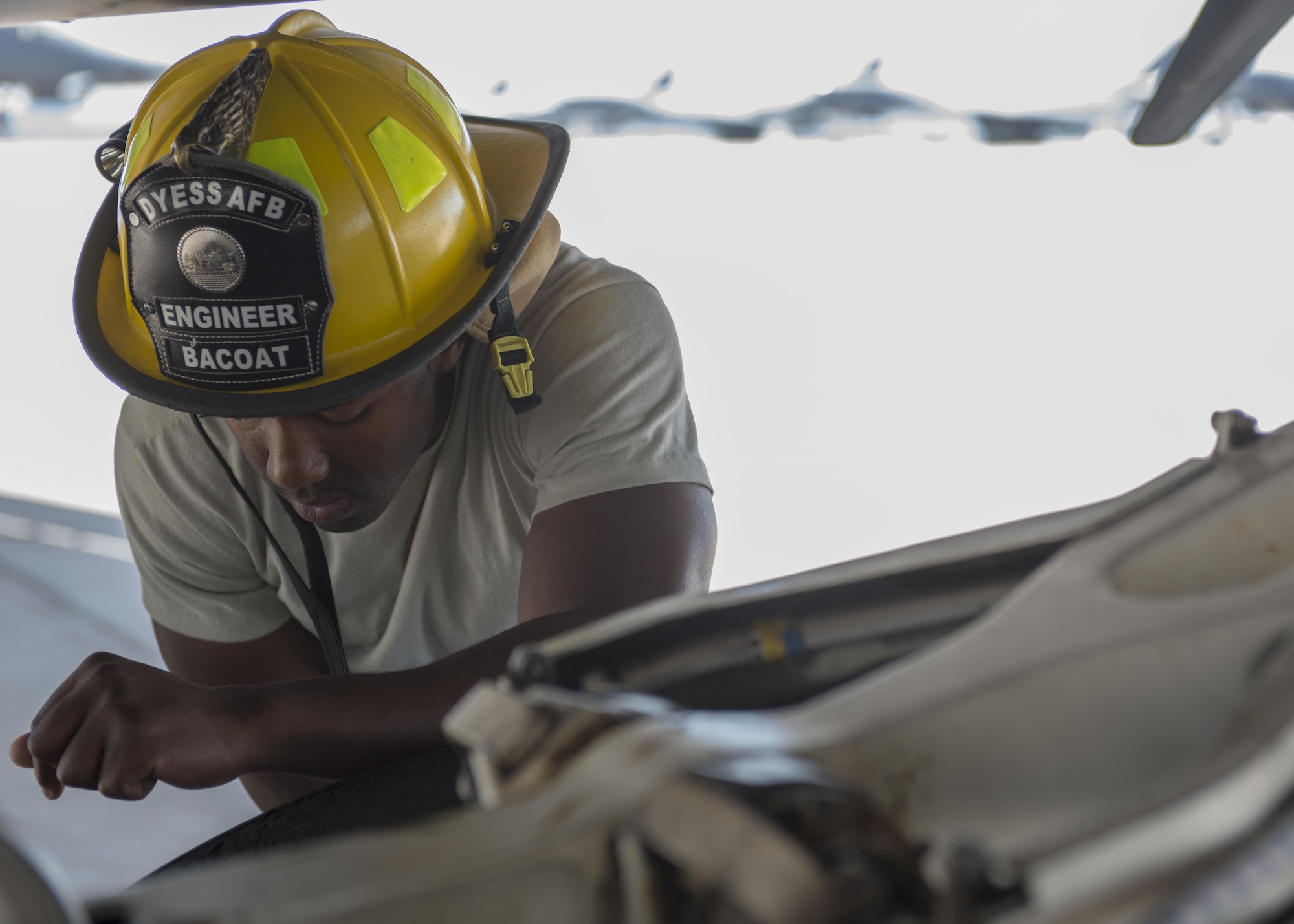 U.S. Air Force Senior Airman Anthony Bacoat, 7th Civil Engineer Squadron Fire Prevention journeyman, assists in a training scenario on a B-1B Lancer at Dyess Air Force Base, Texas, May 22, 2017. Fire Prevention Airmen spend an average of six hours per shift accomplishing training. In addition to training given by leadership for Airmen in upgrade training, the Air Force passes down mandatory monthly training which must be accomplished by every Airman. (U.S. Air Force photo by Airman 1st Class Katherine Miller)