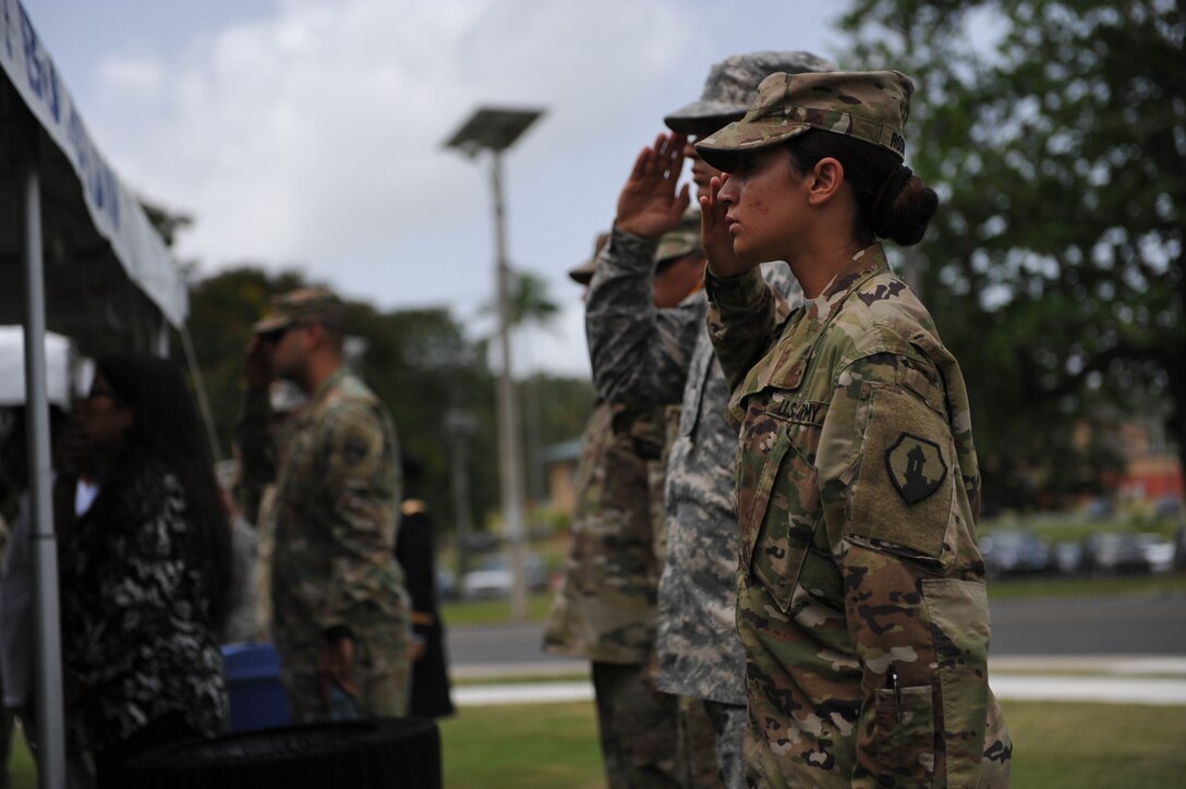 U.S. Army Reserve Soldiers salute during the playing of the national anthem at the Memorial Day ceremony at Soldiers Plaza, on Fort Buchanan, May 24.