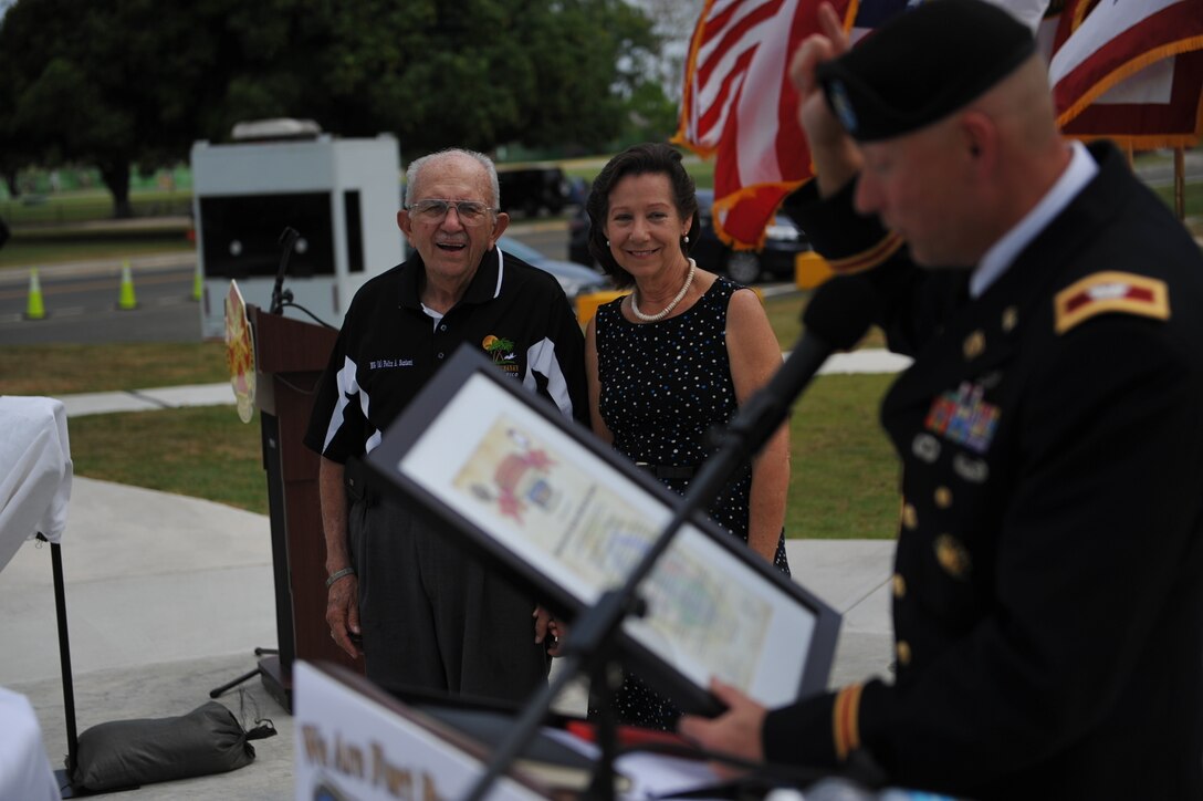 Col. Michael T. Harvey, Fort Buchana Garrison Commander presents the "Sentinel" award to Maj. Gen. (Ret) Felix A. Santoni and his wife Carmen I. Santoni during the Memorial Day ceremony at Soldiers Plaza, on Fort Buchanan, May 24.