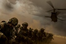 U.S. Air Force and international partners cover themselves as a CH-47 Chinook helicopter takes off at Florence, Ariz., during Angel Thunder 17, May 9, 2017. Angel Thunder is a two-week, Air Combat Command-sponsored, joint certified and accredited personnel recovery exercise focused on search and rescue. The exercise is designed to provide training for personnel recovery assets using a variety of scenarios to simulate deployment conditions and contingencies. (U.S. Air Force photo by Staff Sgt. Corey Hook)