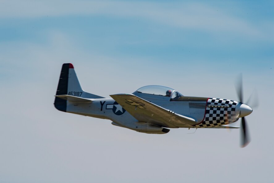 A P-51 Mustang cruises by the crowd after performing the heritage flight, May 19, 2017, at Seymour Johnson Air Force Base, N.C. The heritage flight is performed by multiple aircraft at events throughout the United States. Originally established in 1997, the heritage flight showcases the past, present and future generations of aircraft to bolster recruiting. (U.S. Air Force photo by Staff Sgt. Eric Summers Jr.)