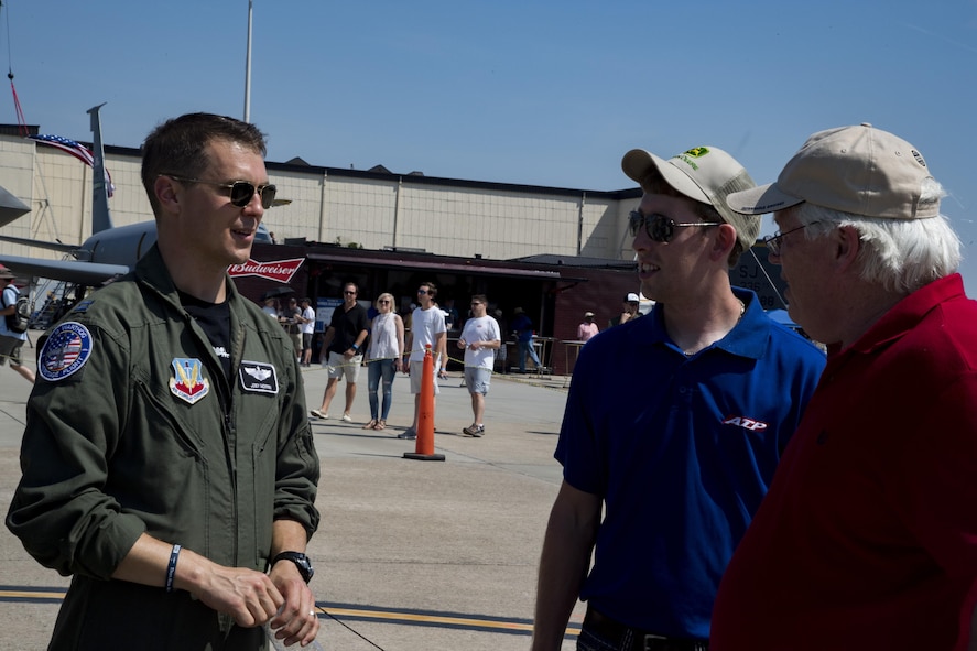 Capt. Joseph Morrin, A-10 East Heritage Team pilot, interacts with attendees during the Wings Over Wayne Airshow 2017, May 20, 2017, at Seymour Johnson Air Force Base, N.C. The heritage flight is performed by multiple aircraft at events throughout the United States. Originally established in 1997, the heritage flight showcases the past, present and future generations of aircraft to bolster recruiting. (U.S. Air Force photo by Staff Sgt. Eric Summers Jr.)