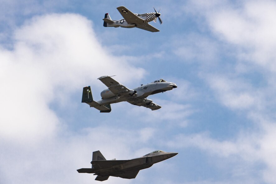 A P-51 Mustang, A-10C Thunderbolt II and F-22 Raptor fly in the heritage formation during the Wings Over Wayne Airshow 2017, May 19, 2017, at Seymour Johnson Air Force Base, N.C. The heritage flight is performed by multiple aircraft at events throughout the United States. Originally established in 1997, the heritage flight showcases the past, present and future generations of aircraft to bolster recruiting. (U.S. Air Force photo by Staff Sgt. Eric Summers Jr.)