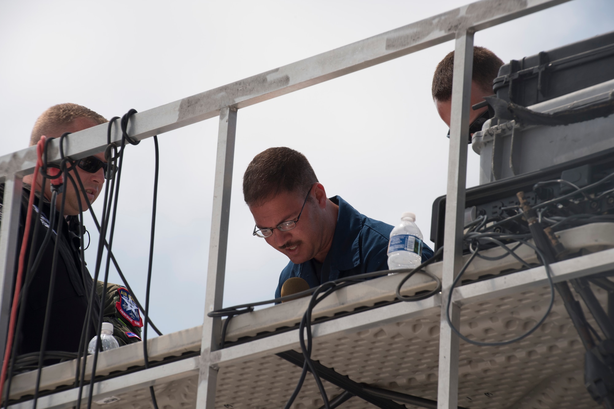Tech. Sgt. James Caruana, team chief for the A-10 East Heritage Team, announces details to the crowd about the history behind the heritage formation, May 20, 2017, at Seymour Johnson Air Force Base, N.C. The heritage flight is performed by multiple aircraft at events throughout the United States. Originally established in 1997, the heritage flight showcases the past, present and future generations of aircraft to bolster recruiting. (U.S. Air Force photo by Staff Sgt. Eric Summers Jr.)