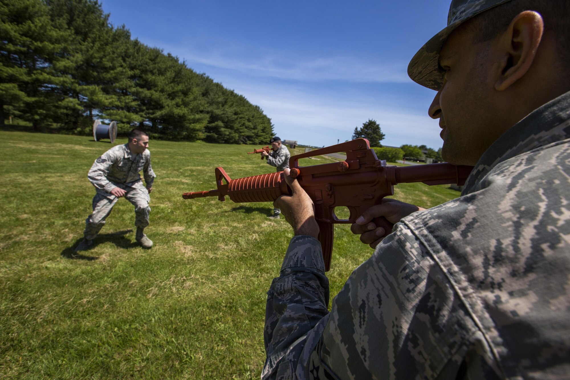 U.S. Air Force 514th Security Forces Squadron members Senior Airmen Shantanu Rai, right, and Morgan D. McDaniel, center, cover Staff Sgt. John J. Provence, left, during static defense operations at Joint Base McGuire-Dix-Lakehurst, N.J., May 21, 2017. The Airmen also practiced simulated defensive fighting positions, handcuffing, challenging and conducting searches. (U.S. Air Force photo by Master Sgt. Mark C. Olsen/Released)