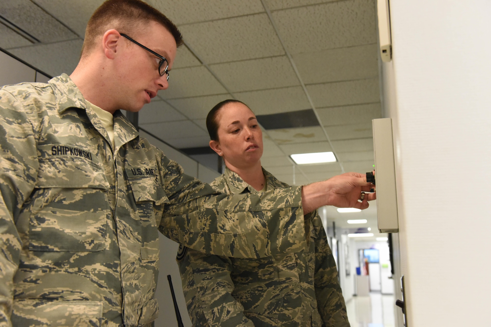 Tech. Sgt. Kurt Shipkowski, 193rd Special Operations Wing, Force Support Squadron, noncommission officer in charge of career development, works with Master Sgt. Jamie Wolf, 193rd SOW, installation emergency management manager, to utilize the building’s mass notification system to notify Airmen of the active shooter during the active shooter exercise on base, May 25, 2017. Wolf and the wing inspection team worked to evaluate how wing members initiate the notification of an active shooter as well as how they react. (U.S. Air National Guard photo by Tech. Sgt. Claire Behney/Released)