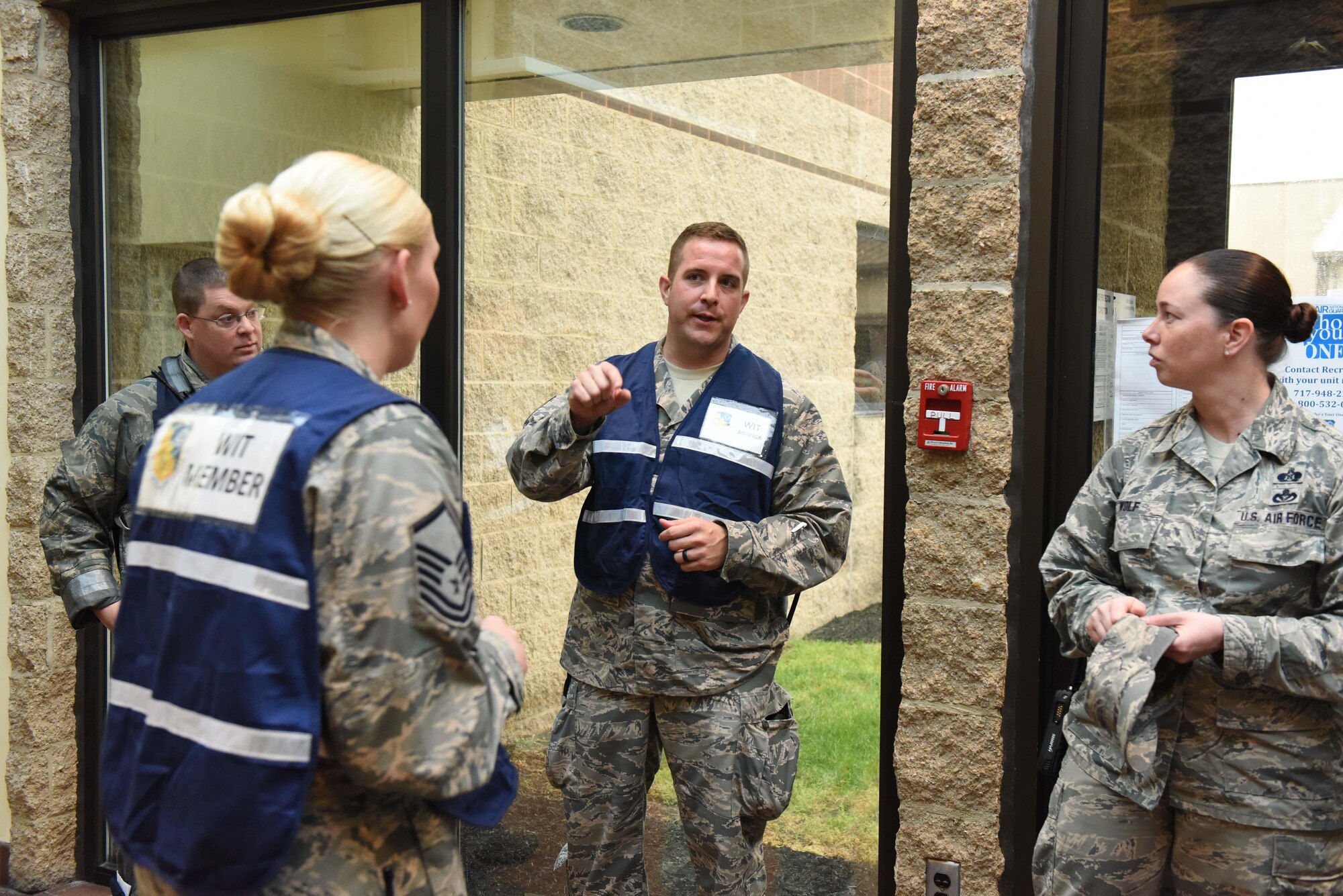Tech. Sgt. Jordan Sherman, 193rd Special Operations Wing, Security Forces Squadron, alternate wing anti-terrorism officer, speaks with wing inspection team members to get their feedback on the inspection of building 79 during the active shooter exercise on base, May 25, 2017. The exercise was conducted as part of base readiness to test wing members’ ability to react properly in the situation of an active shooter. (U.S. Air National Guard photo by Tech. Sgt. Claire Behney/Released)