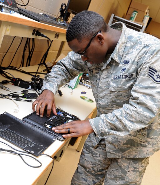 Staff Sgt.  Corrie Hyman, 22nd Communications Squadron client systems technician, examines a laptop in the 22nd CS communication focal point, May 25, 2017, at McConnell air Force Base, Kan. The CFP serves as the one-stop shop for all communication needs and requests for Team McConnell. (U.S. Air Force photo/Staff Sgt. Rachel Waller)