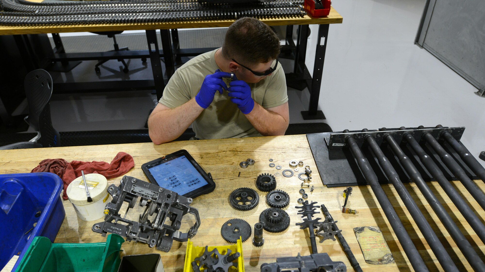 U.S. Air Force Airman 1st Class Michael Tilton, 20th Equipment Maintenance Squadron weapons technician, holds a bearing to his ear at Shaw Air Force Base, S.C., May 22, 2017. Tilton was listening for audible scraping in the M61A1 Vulcan 20 mm rotary cannon exit unit bearing to determine if the bearing needed replacement. (U.S. Air Force photo by Airman 1st Class Kathryn R.C. Reaves)