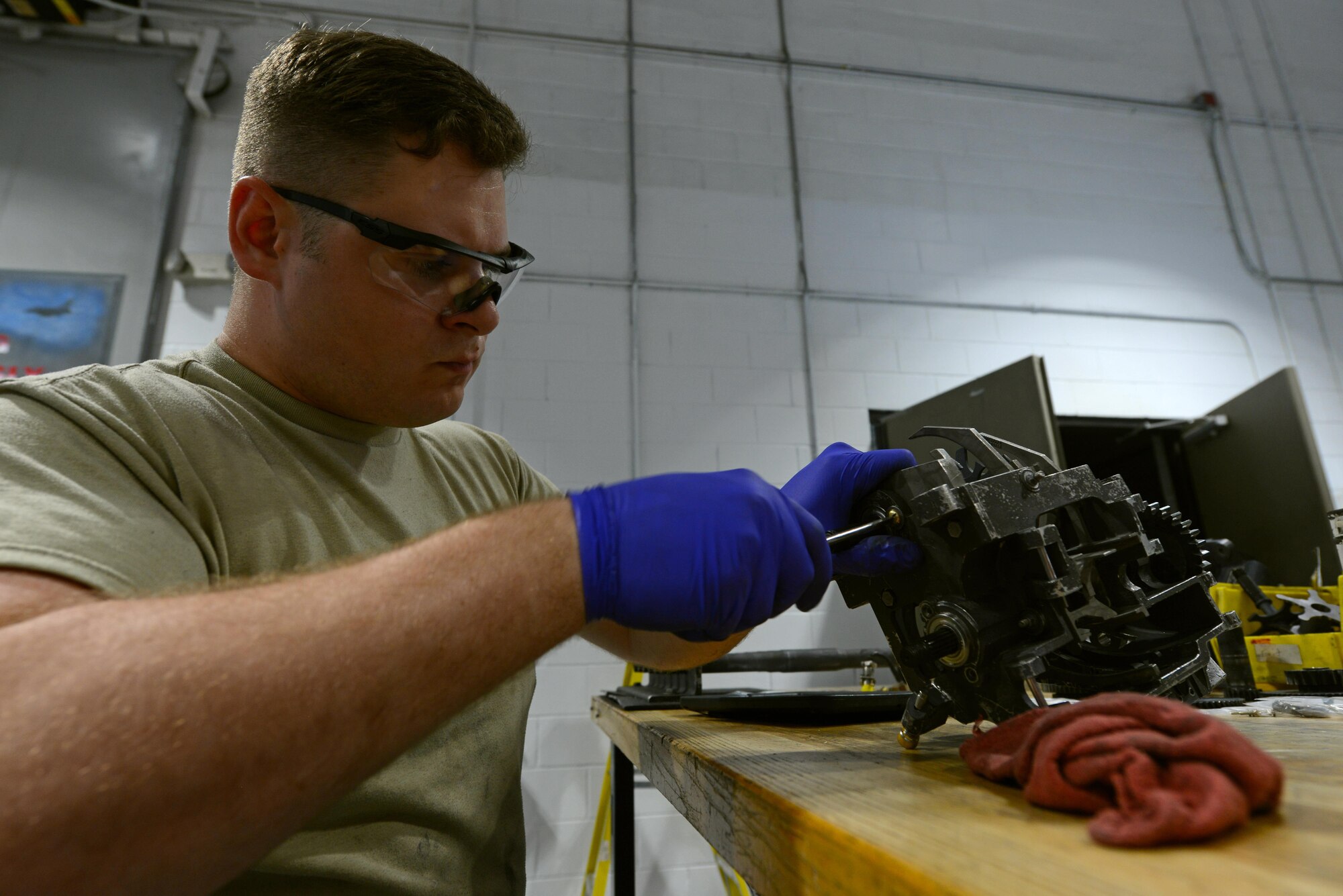 U.S. Air Force Airman 1st Class Michael Tilton, 20th Equipment Maintenance Squadron weapons technician, uses a hammer and punch to secure roll pins on a M61A1 Vulcan 20 mm rotary cannon exit unit at Shaw Air Force Base, S.C., May 22, 2017. The roll pins hold sprockets on the unit’s gear shaft, allowing the unit to pull munitions from the drum and towards the gun. (U.S. Air Force photo by Airman 1st Class Kathryn R.C. Reaves)