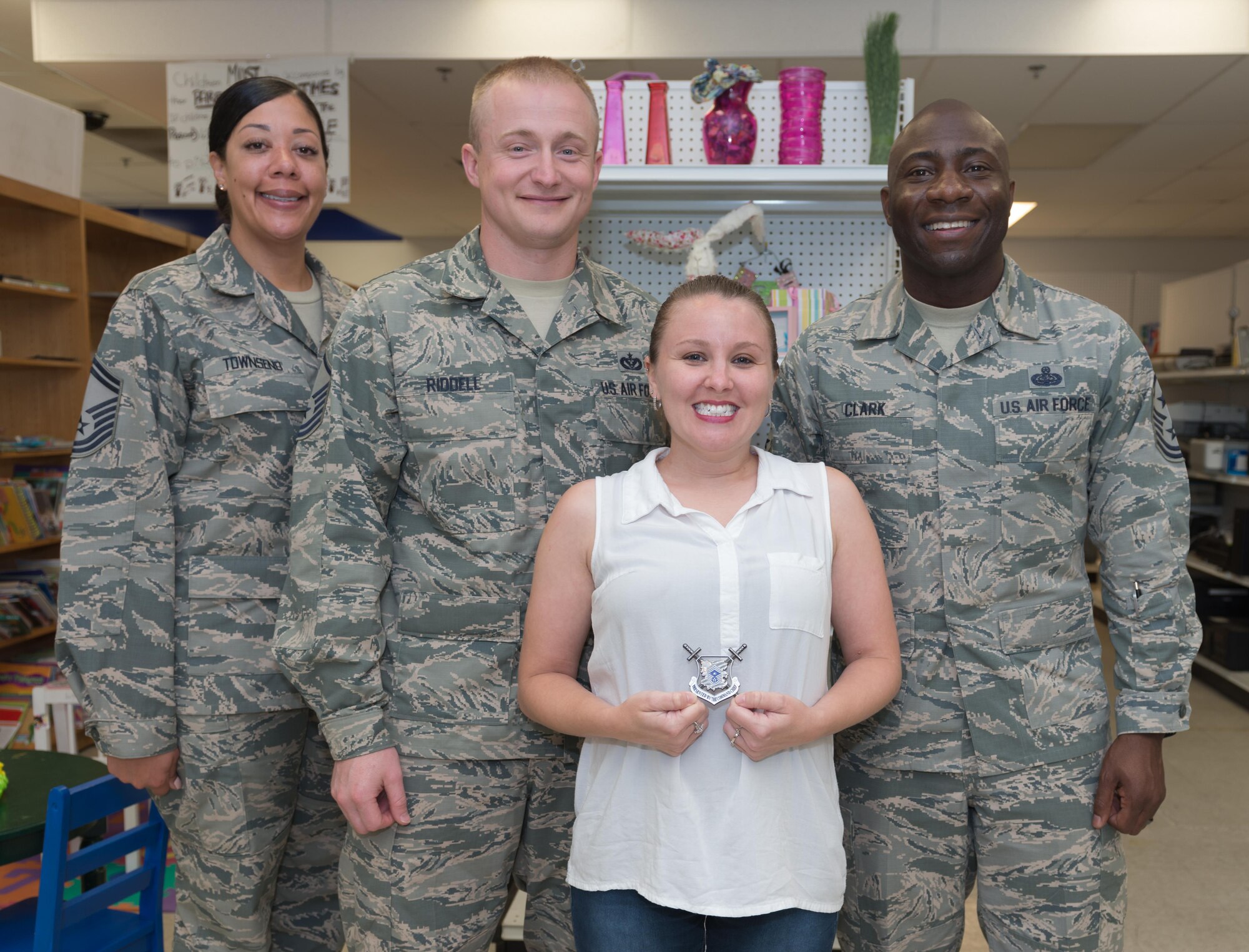 Brandy Lee Riddell, Airman’s Attic lead volunteer, poses for a photo with base leadership and her spouse, Master Sgt. James Riddell, Mathies NCO Academy curriculum and analysis superintendent at the Airman’s Attic May 24, 2017, on Keesler Air Force Base, Miss. Riddell was recognized by Chief Master Sgt. Vegas Clark, 81st Training Wing command chief, for her hard work in overseeing and organizing the donations and supplies for the base’s 12,000 Airmen. (U.S. Air Force photo by Andre’ Askew)

