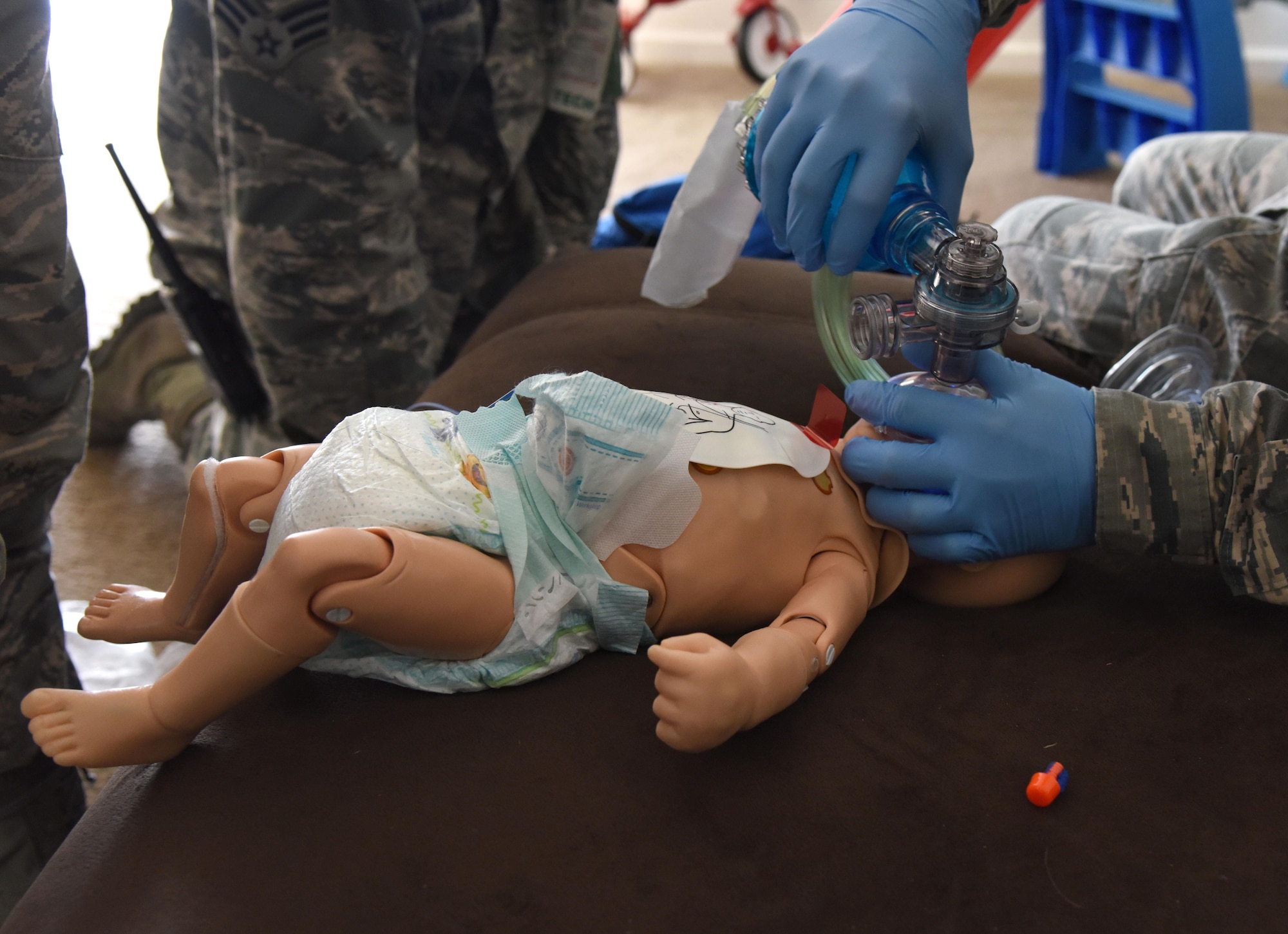 Airman 1st Class Andrew Frost, 81st Medical Operations Squadron medical technician, simulate cardiopulmonary resuscitation on an infant “patient” found unresponsive during a medical emergency scenario in East Falcon subdivision May 24, 2017, in Biloxi, Miss. Emergency room staff members coordinated with the simulation lab to use human patient simulators for running various advanced cardiac life support scenarios to improve Keesler’s new medical technicians’ skills and get them familiar with emergency equipment. (U.S. Air Force photo by Kemberly Groue)