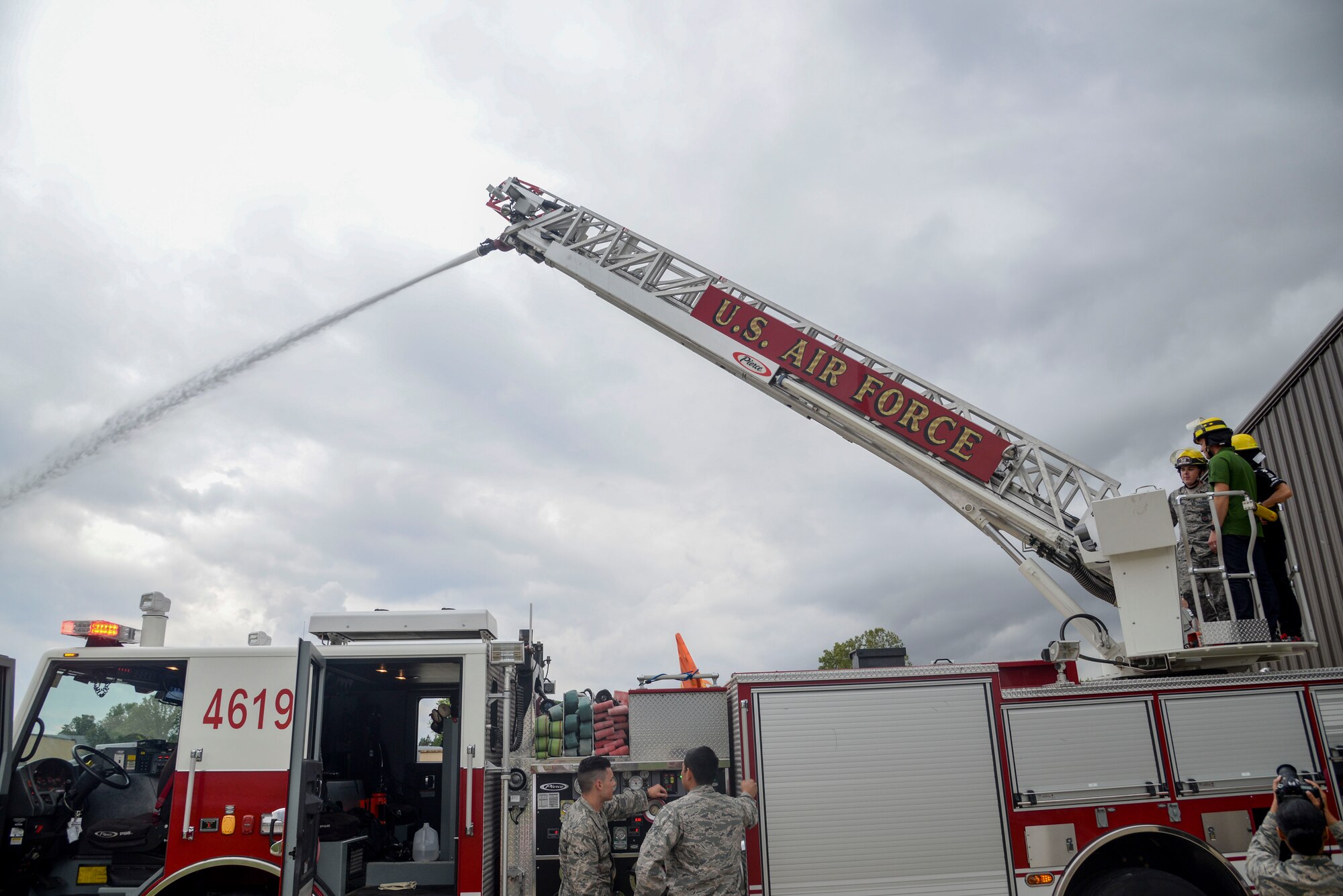 Members from the 375th Civil Engineer Squadron show Takuma Sato and Ed Carpenter, Indy Car Series drivers, the in and outs of a fire truck during their visit May 23, 2017 to Scott Air Force Base.During the visit, the drivers met with Airmen from different squadrons on the base to learn what Scott brings to the mission.(U.S. Air Force photos by Airmen Chad Gorecki)