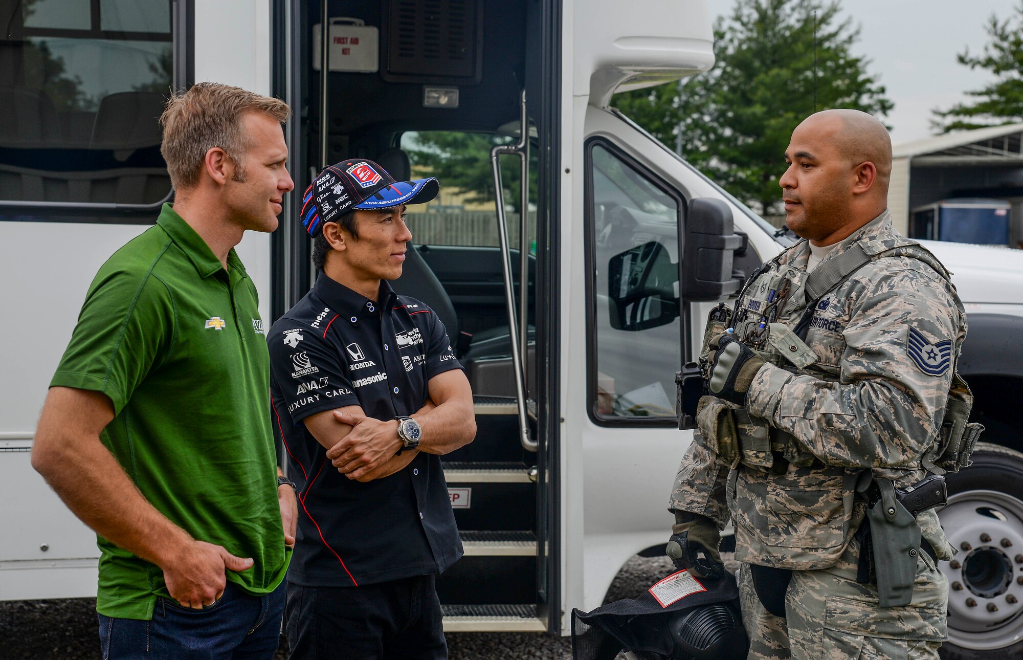 Ed Carpenter and Takuma Sato, Indy Car Series drivers, speak with Tech. Sgt. James Booker of 375th Security Forces Squadrons during their visit May 23, 2017 at Scott Air Force base Illinois. The drivers met with Airmen from several suadrons to learn about what Scott AFB brings to the fight.(U.S. Air Force photo by Airman Chad Gorecki)