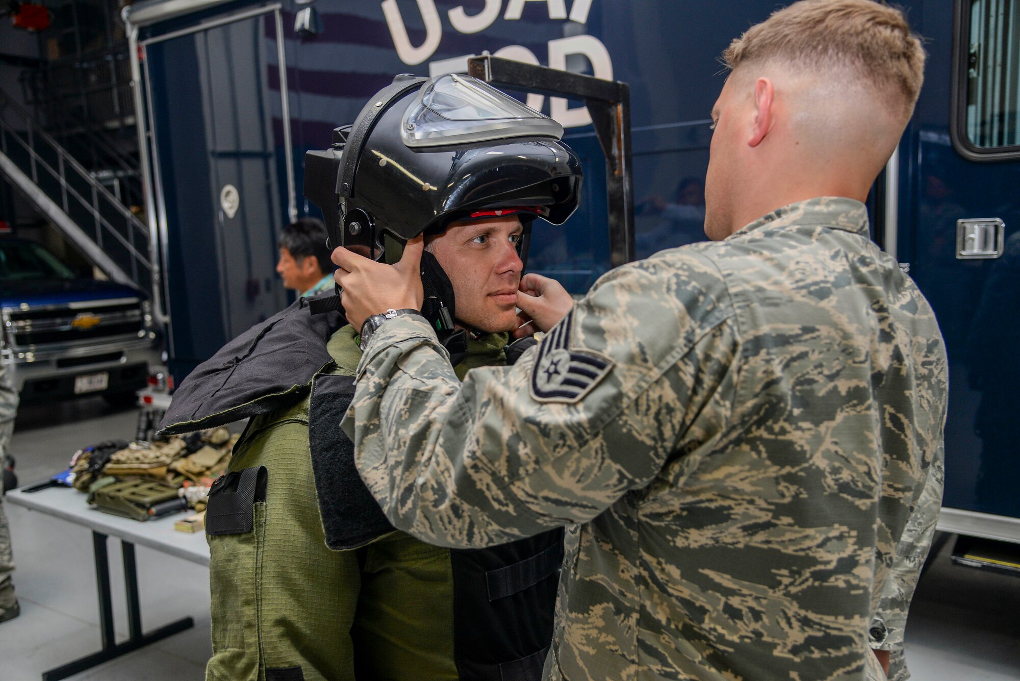 Ed Carpenter, Indy Car Series Driver, tries on the Explosive Ordinance Disposal bomb-suit during a visit May 23, 2017 to Scott Air Force Base. The drivers met with Airmen from several suadrons to learn about what Scott AFB brings to the fight.(U.S. Air Force photo by Airman Chad Gorecki)