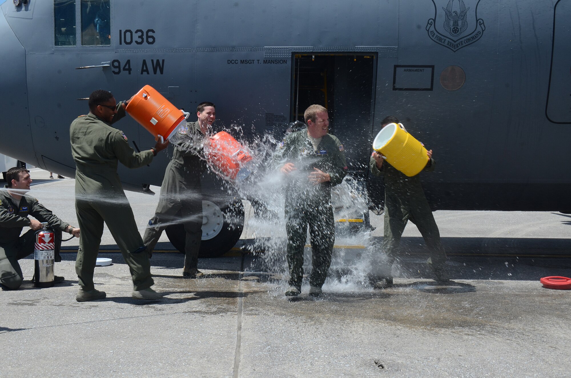 Being honored for 33 years of military service, Master Sgt. Steve Belcher, 700th Airlift Squadron loadmaster, is doused with water after his final C-130 flight at Dobbins Air Reserve Base May 25, 2017. Dating back to World War II, aircrew members have celebrated their last flights in similar fashion. Over the years, it has become an Air Force tradition for flyers. (U.S. Air Force photo/Don Peek)