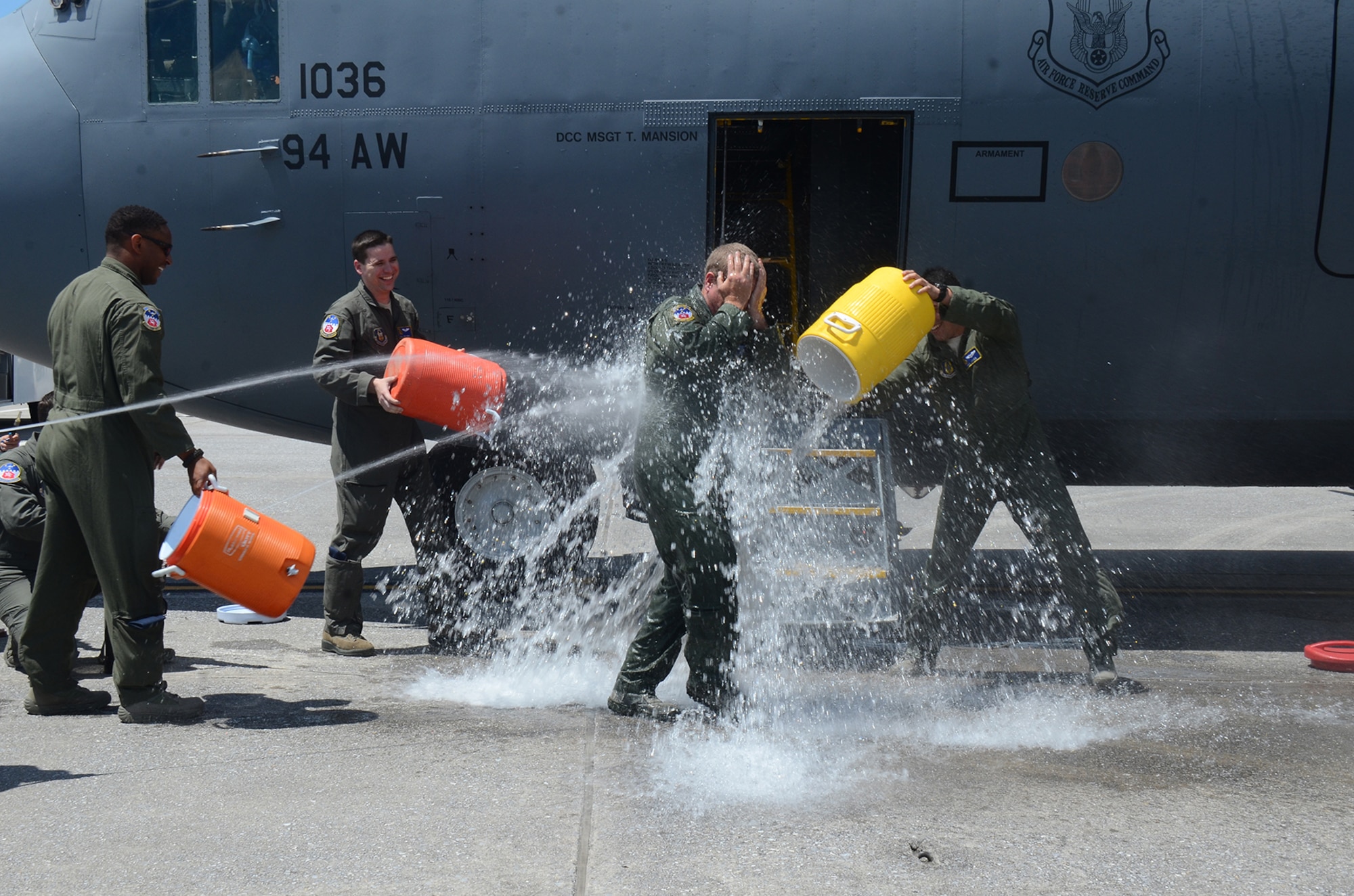 Being honored for 33 years of military service, Master Sgt. Steve Belcher, 700th Airlift Squadron loadmaster, is doused with water after his final C-130 flight at Dobbins Air Reserve Base May 25, 2017. Dating back to World War II, aircrew members have celebrated their last flights in similar fashion. Over the years, it has become an Air Force tradition for flyers. (U.S. Air Force photo/Don Peek)