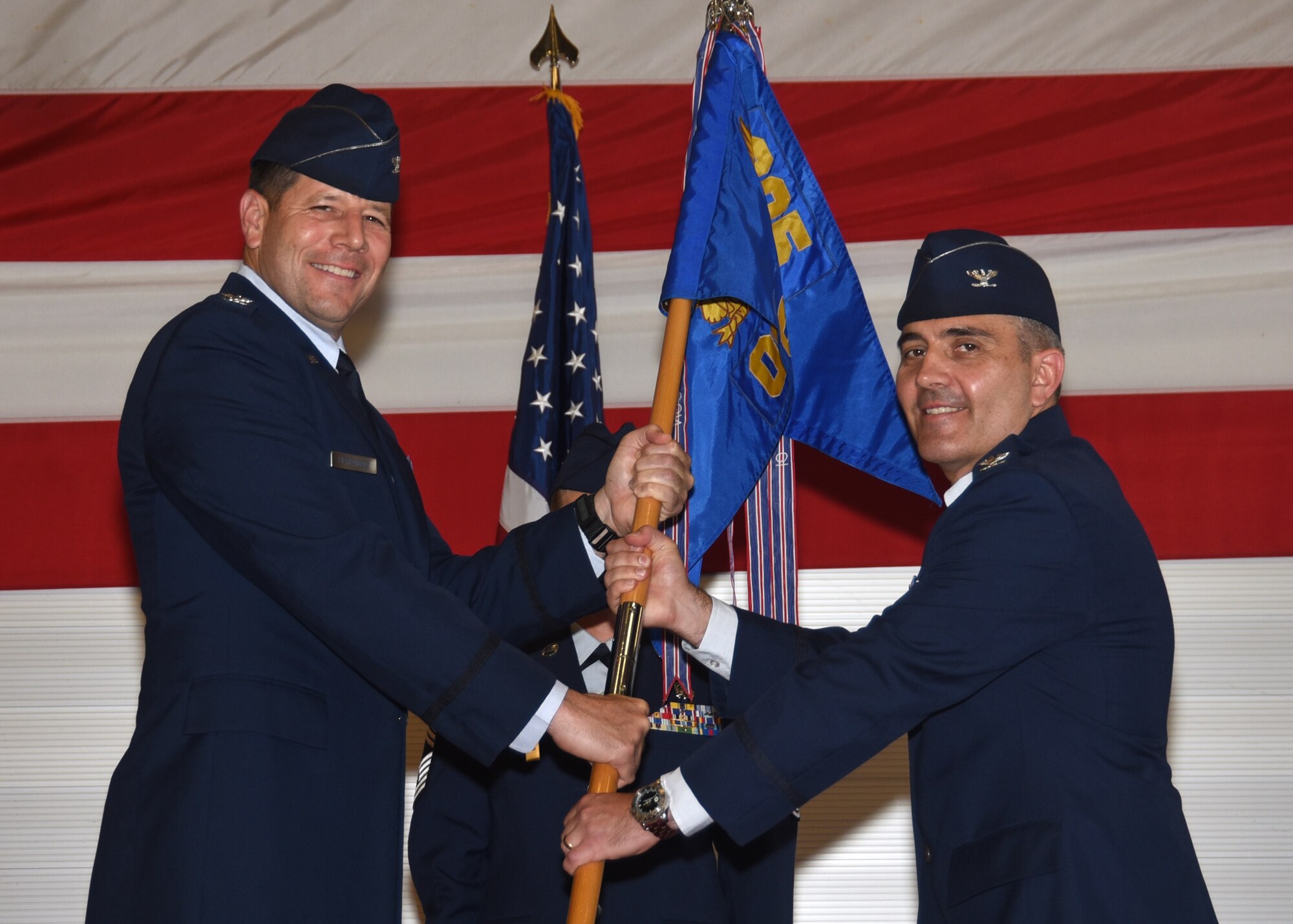 U.S. Air Force Col. Michael Hernandez, 325th Fighter Wing commander (left), presents the 325th Operations Group guidon to the new commander, Col. Christian D. Kane, during the 325th OG change of command ceremony at Tyndall Air Force Base, Fla., May 25, 2017. The 325th Operations Group is comprised of two fighter squadrons, a fighter training squadron, a training support squadron and an operations support squadron. (U.S. Air Force photo by Airman 1st Class Isaiah Soliz/Released) 
