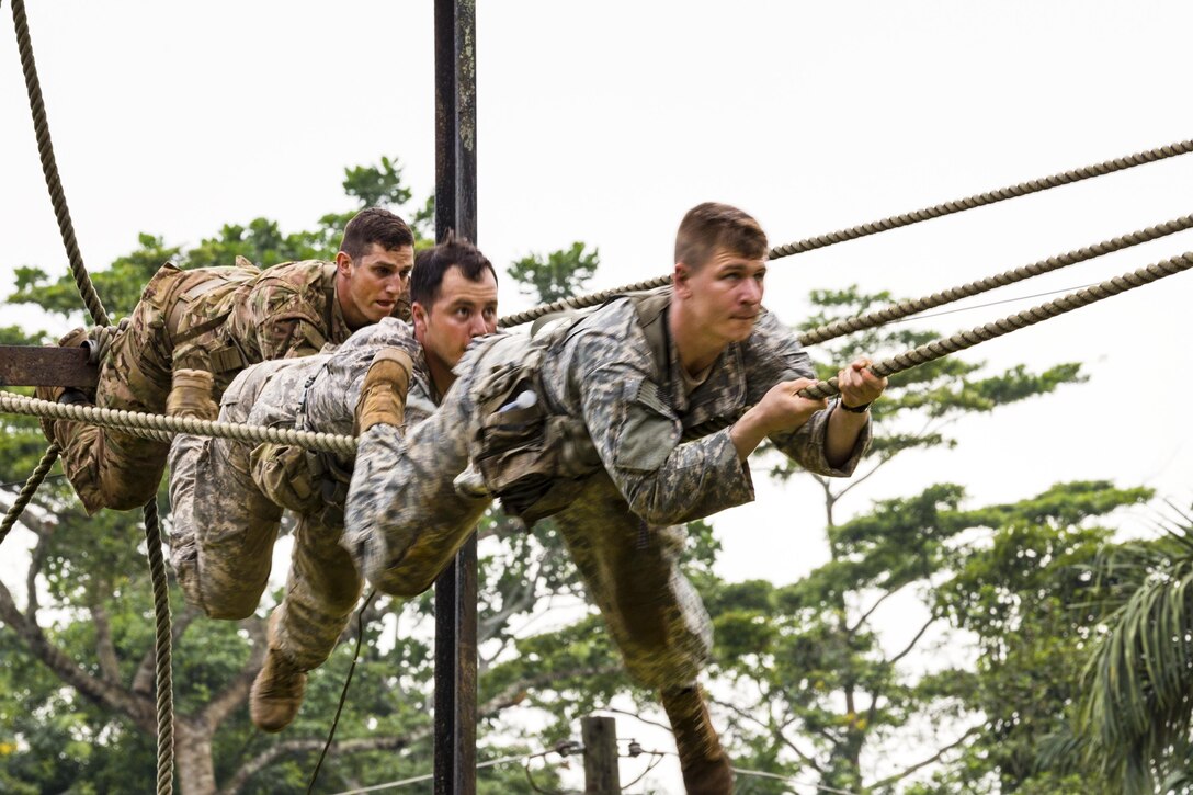 Soldiers climb across a rope during United Accord 2017 at the Jungle Warfare School in Achiase military base in Akim Oda, Ghana, May 20, 2017. The school provides a series of exercises to train participants in counterinsurgency and internal security operations. Army photo by Spc. Victor Perez Vargas


