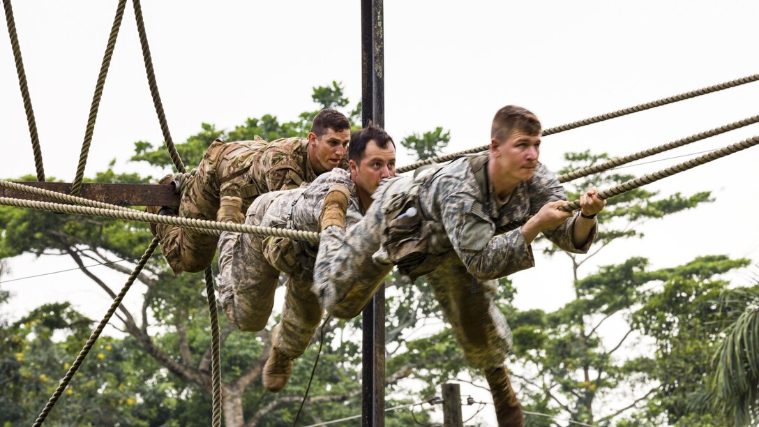 Soldiers climb across a rope during United Accord 2017 at the Jungle Warfare School in Achiase military base in Akim Oda, Ghana, May 20, 2017. The school provides a series of exercises to train participants in counterinsurgency and internal security operations. Army photo by Spc. Victor Perez Vargas

