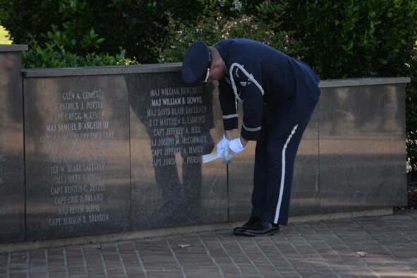 Senior Airman Jacob Bolton, Columbus Air Force Base Honor Guardsman, unveils the name of a former 14th Flying Training Wing Airman during a formal Memorial Day Retreat Ceremony May 25, 2017, at the Gene Smith Plaza on
Columbus Air Force Base, Mississippi. One side of the plaza wall displays the names of previously assigned Columbus AFB pilots who were killed in military aircraft accidents. Capt. Jordan Pierson, a Specialized Undergraduate Pilot Training Class 12-07 graduate, died Oct. 2, 2015, in a tragic C-130J Super Hercules crash in Jalalabad Airfield, Afghanistan. (U.S. Air Force photo by Airman 1st Class Keith Holcomb)

