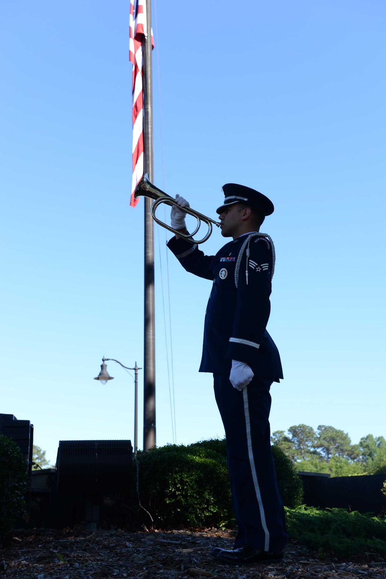 Senior Airman Luis Serrano Solano, Columbus Air Force Base Honor Guardsman, begins to play Taps during the Memorial Day Retreat Ceremony May 25, 2017, on Columbus AFB, Mississippi. The Memorial Day Ceremony honored our Nation’s fallen airmen, soldiers, sailors, and marines, and included a special Memorial Service for Capt. Jordan B. Pierson. (U.S. Air Force photo by Senior Airman John Day)