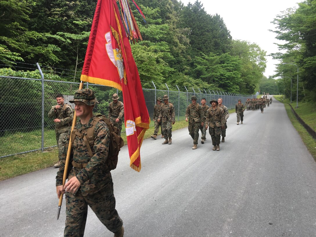 Sgt. Maj. Bradly Simmons carries the battalion guidon during a 50-mile hike challenge, May 15-17, 2017, at Combined Arms Training Center Camp Fuji, Japan. The 50-mile hike challenge dates back to 1908 when President Theodore Roosevelt signed Executive Order 989 requiring lieutenants and captains in the Marine Corps to walk 50-miles in no more than 20 hours. Simmons is the battalion sergeant major of 3rd Battalion, 8th Marine Regiment. (Photo courtesy of Lt. Col. Kemper Jones)