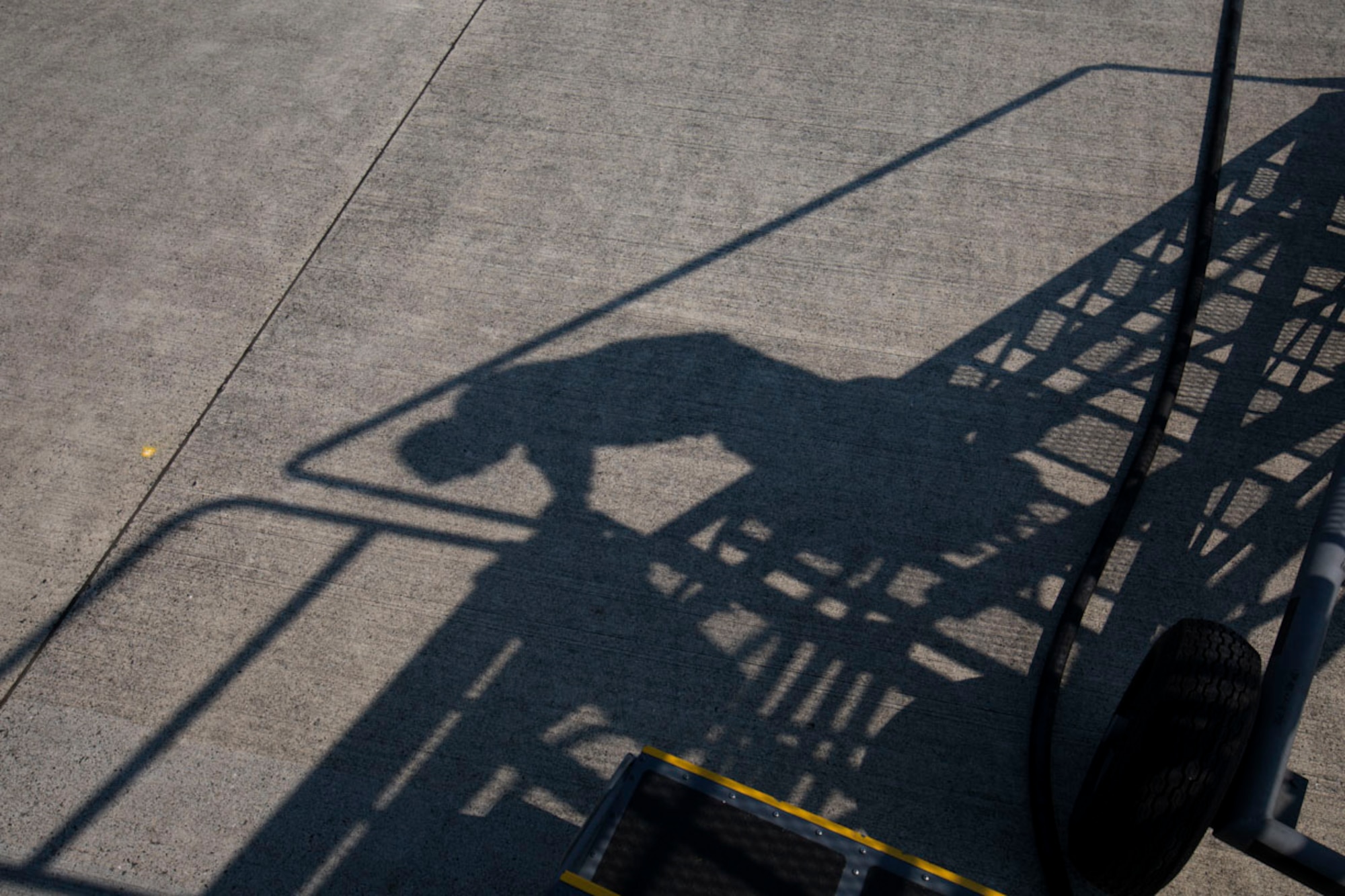Airman 1st Class Caleb Cauthorn, 374th Maintenance Squadron aircraft structural maintenance journeyman, climbs a stair away at Yokota Air Base, Japan, May 19, 2017. Airmen with the 374th MXS placed the nose art on the 3rd C-130J Super Hercules to recently arrive at Yokota. (U.S. Air Force photo by Yasuo Osakabe)