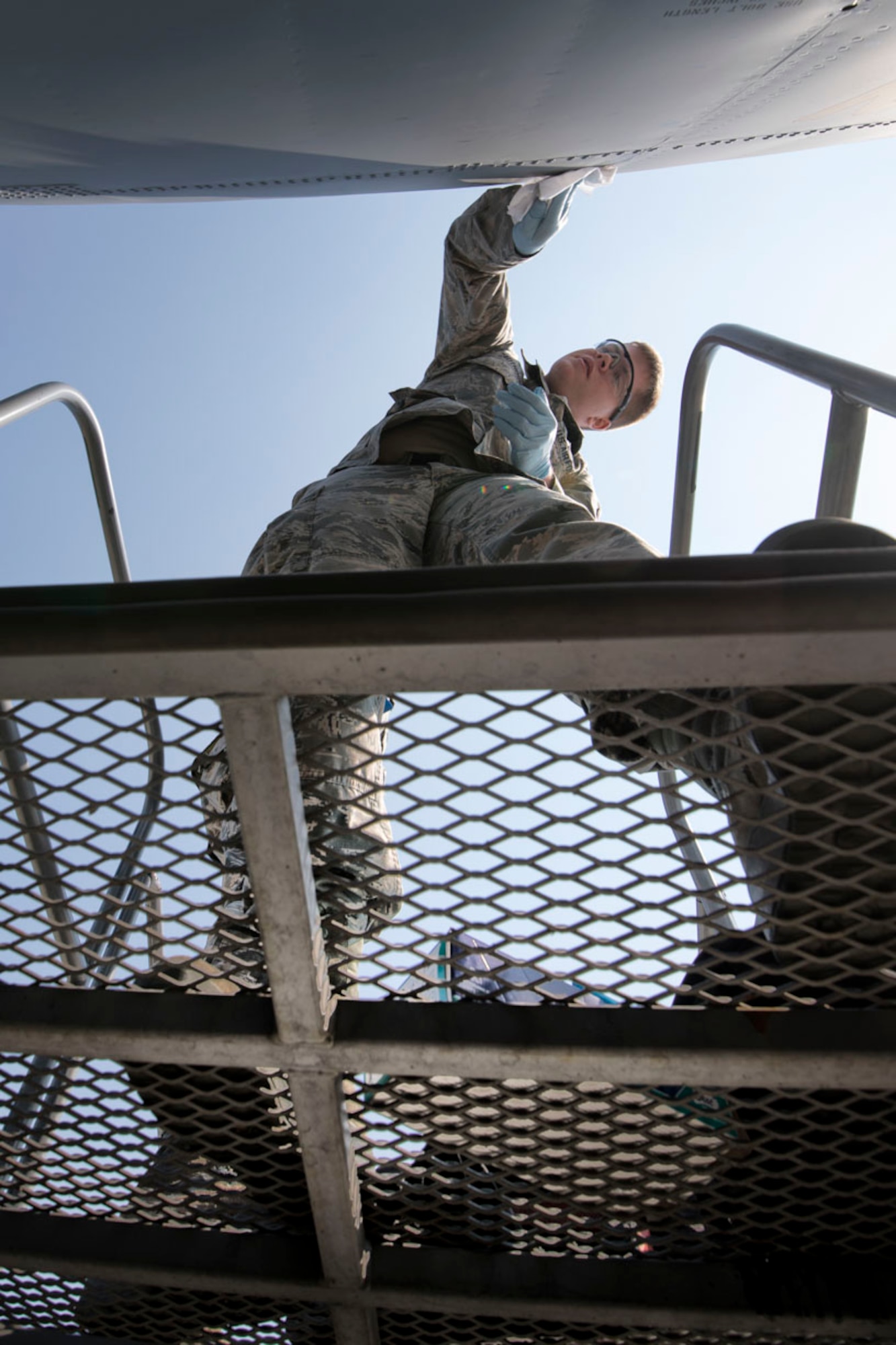 Airman 1st Class Caleb Cauthorn, 374th Maintenance Squadron aircraft structural maintenance journeyman, cleans the surface of a C-130J Super Hercules before placing the new nose art at Yokota Air Base, Japan, May 19, 2017. The 3rd C-130J arrived at Yokota on May 4. (U.S. Air Force photo by Yasuo Osakabe)