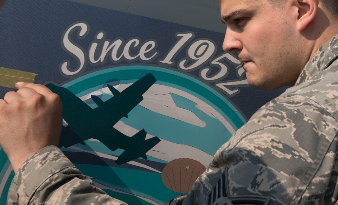 Staff Sgt. Jared Boles, 374th Maintenance Squadron aircraft structural maintenance craftsman, delicately places nose art onto a C-130J Super Hercules at Yokota Air Base, Japan, May 19, 2017. The nose art design, "Spirit of Hope," which was designed and donated by graphic artist Samantha Beaty, celebrates the United States Air Force's dedication to providing humanitarian assistance and disaster relief to nations throughout the Indo-Asia-Pacific region. Since 1952, Yokota Air Base has been delivering hope throughout the Pacific area. By delivering HA/DR or airlift support, the USAF aircraft tail marking “YJ” have become, "Symbols of Hope," for people throughout the Pacific.  (U.S. Air Force photo by Yasuo Osakabe)