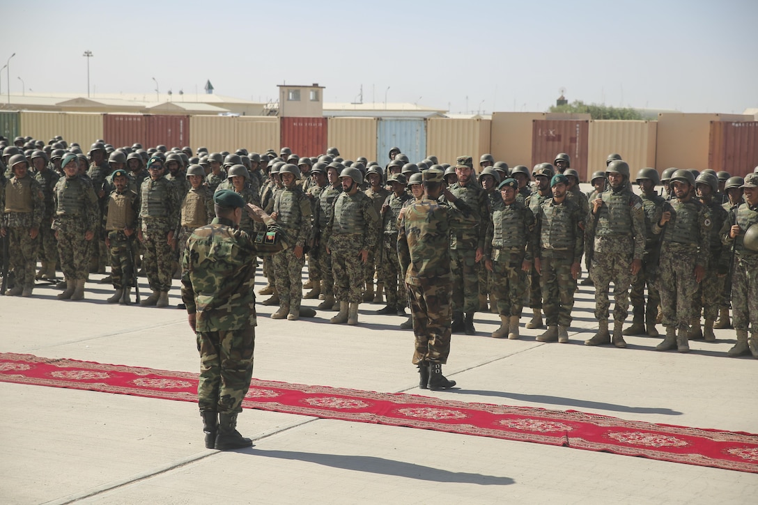 Afghan National Army Brig. Gen. Abdul Hadi Khalil, left, the deputy commanding general of the 215th Corps, salutes ANA soldiers with the 2nd Kandak, 4th Brigade during an opening ceremony for an operational readiness cycle at Camp Shorabak, Afghanistan, May 20, 2017. U.S. Marine advisors with Task Force Southwest will assess and make recommendations for sustainment and improvements throughout the eight-week course, which is led by the Helmand Province Regional Military Training Center. More than 600 ANA soldiers will develop their technical and tactical infantry skills to help thwart enemy presence in the region. (U.S. Marine Corps photo by Sgt. Lucas Hopkins)