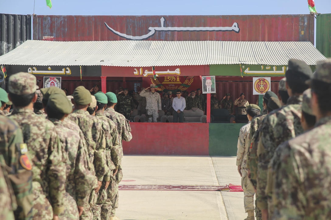 U.S. Marines with Task Force Southwest and Afghan National Army soldiers with the 215th Corps salute during the playing of the Afghan National Anthem at Camp Shorabak, Afghanistan, May 20, 2017. Service members from both nations gathered for an opening ceremony recognizing 2nd Kandak, 4th Brigade’s commencement of the operational readiness cycle, an eight-week training program which builds the infantry and warfighting capabilities of the Afghan soldiers. Approximately 15 Marine advisors will assess and make recommendations to the Afghan trainers as part of the Task Force’s train, advise and assist mission in Helmand Province. (U.S. Marine Corps photo by Sgt. Lucas Hopkins)