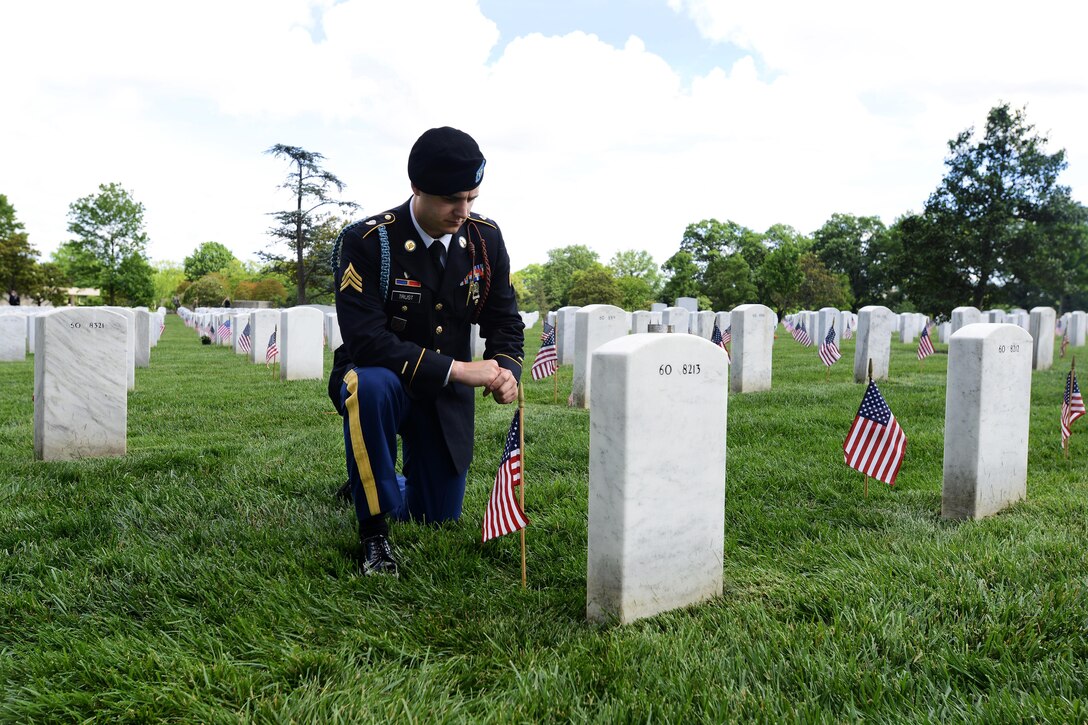 Georgia Army National Guard Sgt. Daniel Trust pays respects to his close friend, Army Capt. Jeremy A. Chandler, who was killed in action during Operation Enduring Freedom during "Flags In" at Arlington National Cemetery in Arlington, Va., May 25, 2017. Trust is an infantryman assigned to the Georgia Army National Guard’s 3rd Infantry Division, Company C, 2nd Battalion, 121st Infantry Brigade. DoD photo by Sebastian J. Sciotti Jr. 